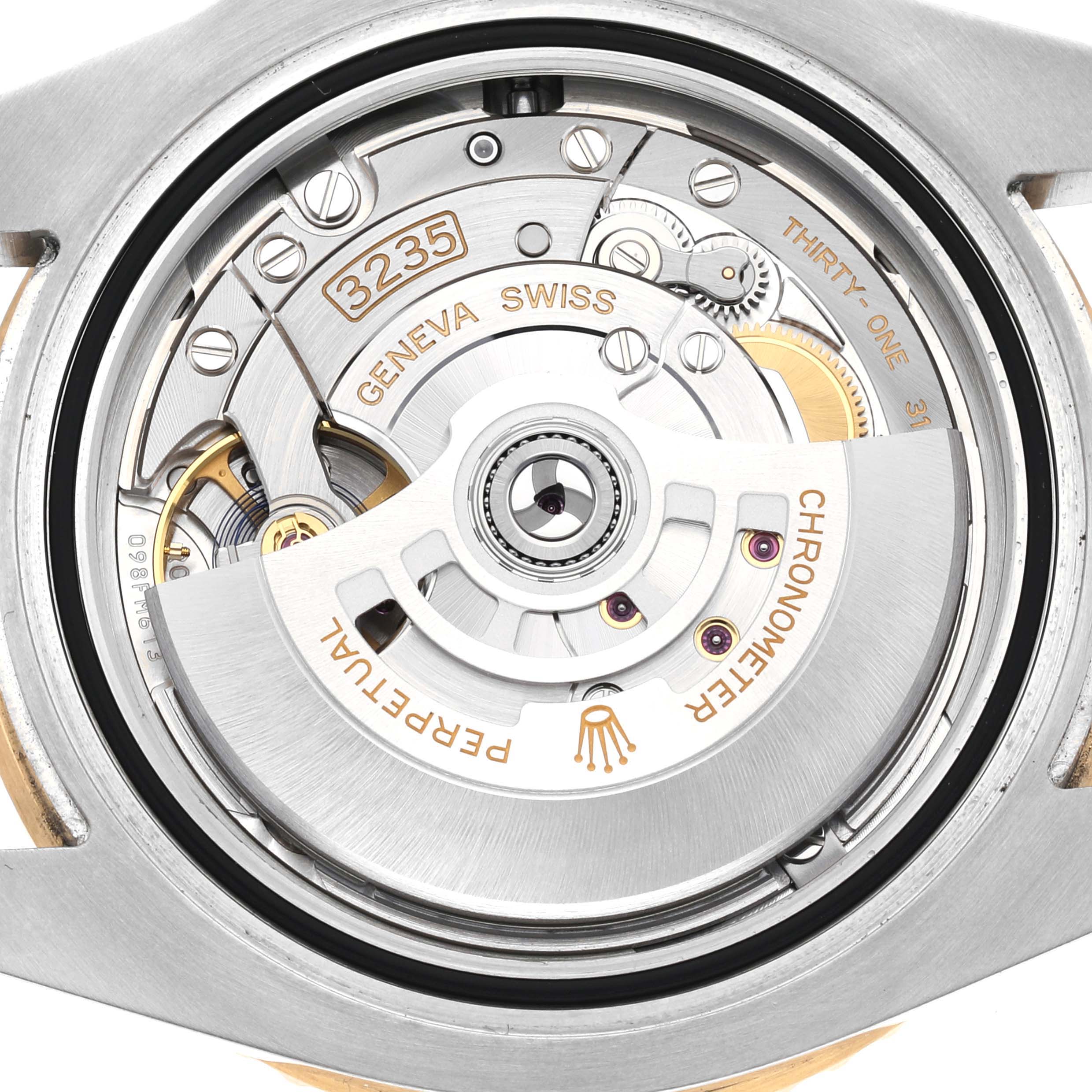 This image shows the back view of a Rolex Submariner 126613LN Men's Steel and Gold (two tone) Black Dial 126613LN Men's Steel and Gold (two tone) Black Dial, highlighting its movement mechanism with the rotor and various internal components.