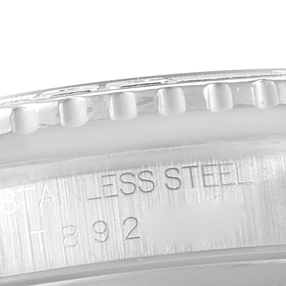 This image shows a close-up of the bezel and part of the engraved inner case of a Rolex Turn-o-Graph 16264 Men's Stainless Steel Silver Dial 16264 Men's Stainless Steel Silver Dial watch.