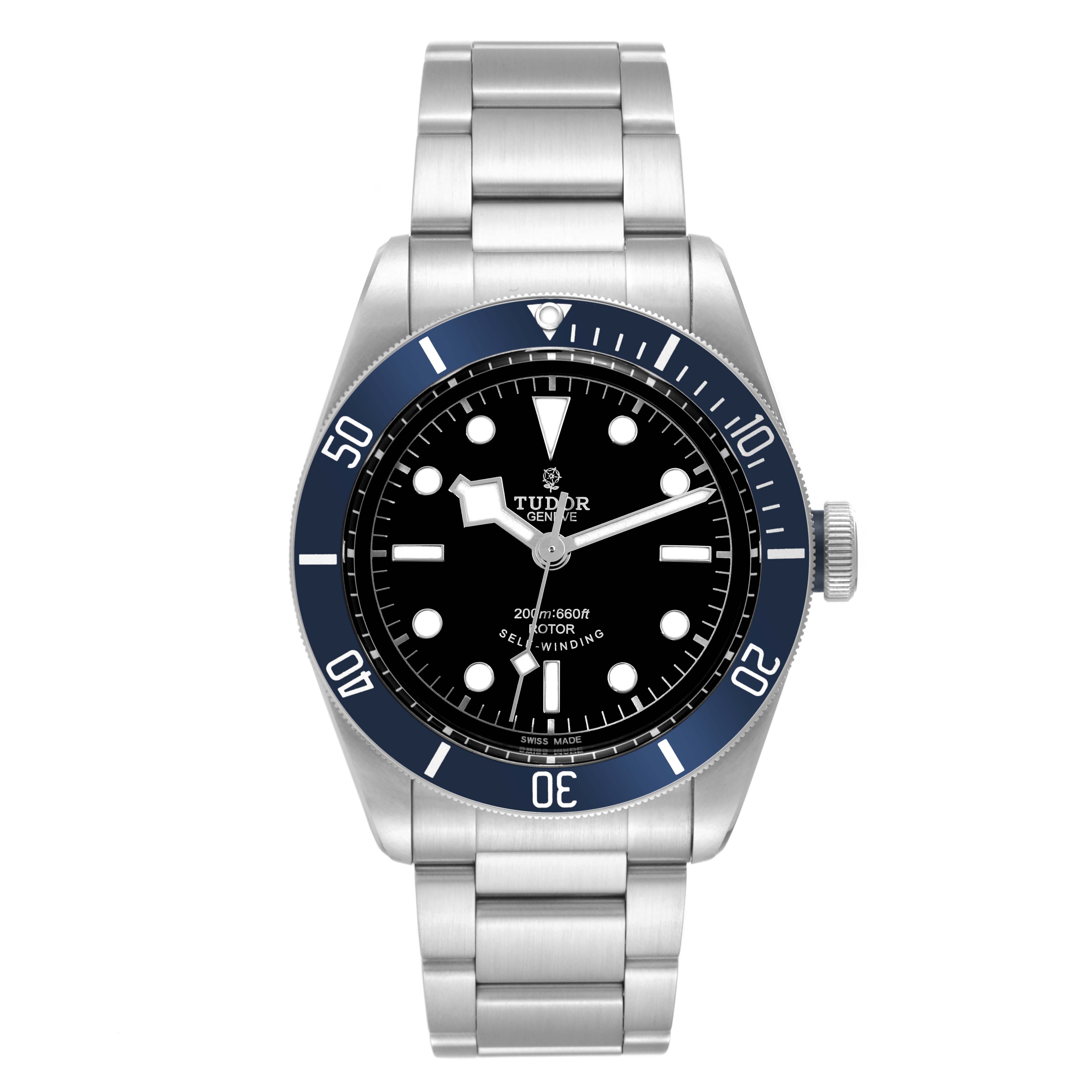The image displays a Tudor Heritage Black Bay 79220B Men
s Stainless Steel Black Dial 79220B Men
s Stainless Steel Black Dial watch from a front angle, showing the dial, bezel, and bracelet.