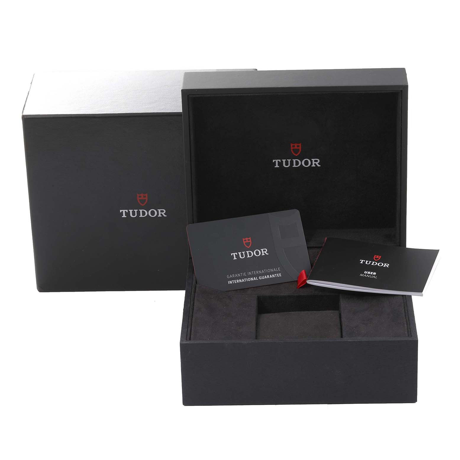 The image shows the packaging, warranty card, and user manual for the Tudor Heritage Black Bay 79220B Men
s Stainless Steel Black Dial 79220B Men
s Stainless Steel Black Dial watch.