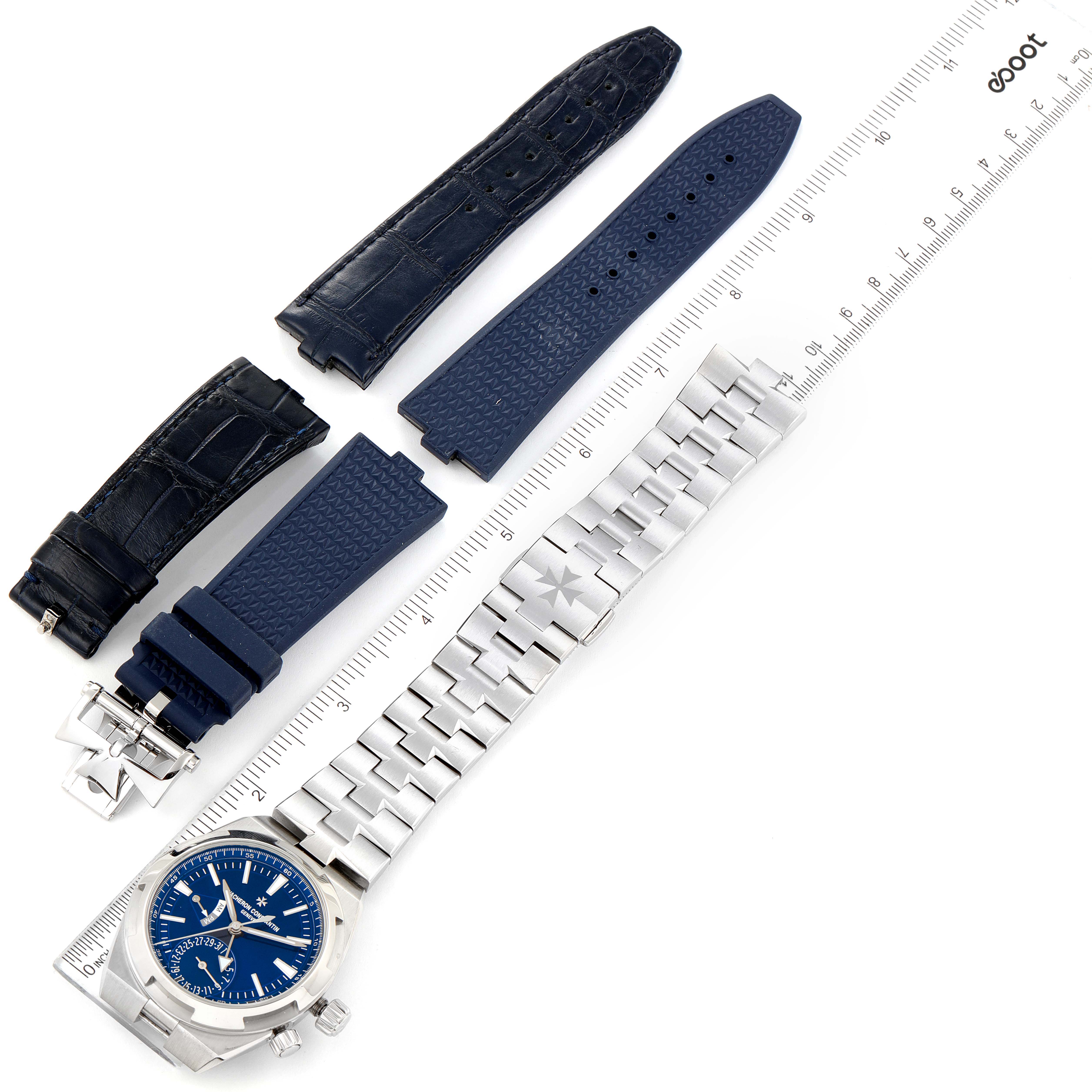 The image shows a top view of the Vacheron Constantin Overseas 7900V/110A-B334 Men's Stainless Steel Blue Dial 7900V/110A-B334 Men's Stainless Steel Blue Dial watch, including metal and rubber straps, with a ruler for scale.