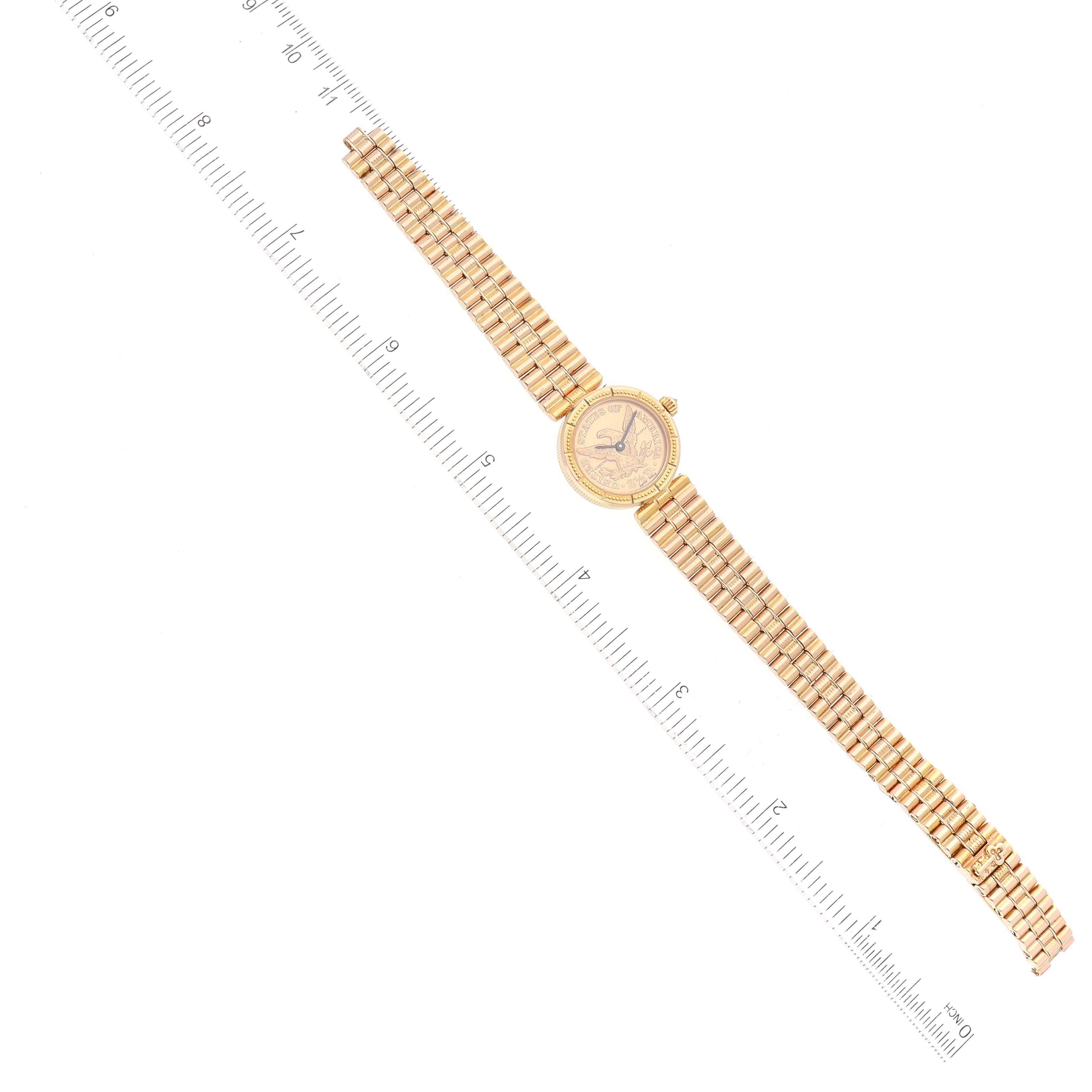 The image displays a Corum 1852 Women
s Yellow Gold Champagne Dial 1852 Women
s Yellow Gold Champagne Dial 2.5 Dollars Eagle Liberty Coin Yellow Gold Ladies Watch 1852 model from a top-down angle with a ruler for scale.