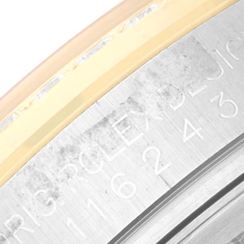 The image shows a close-up of the engraved casing of a Rolex Datejust 116243 Men's Steel and Gold (two tone) Champagne Dial 116243 Men's Steel and Gold (two tone) Champagne Dial watch.