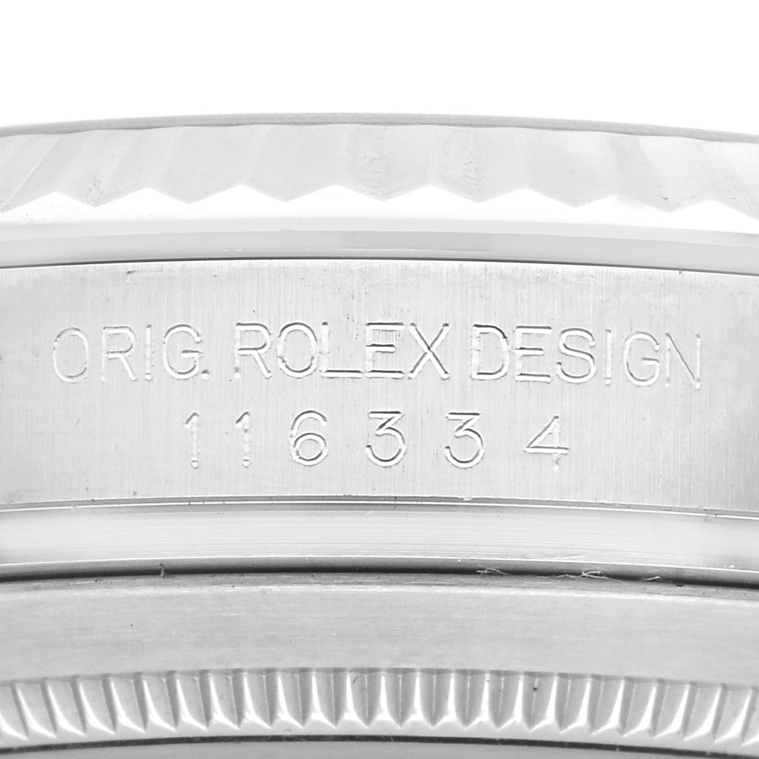 The image shows a close-up of the side of the Rolex Datejust 116334 Men
s Stainless Steel Silver Dial 116334 Men
s Stainless Steel Silver Dial watch case, displaying the "ORIG. ROLEX DESIGN" engraving and a serial number.