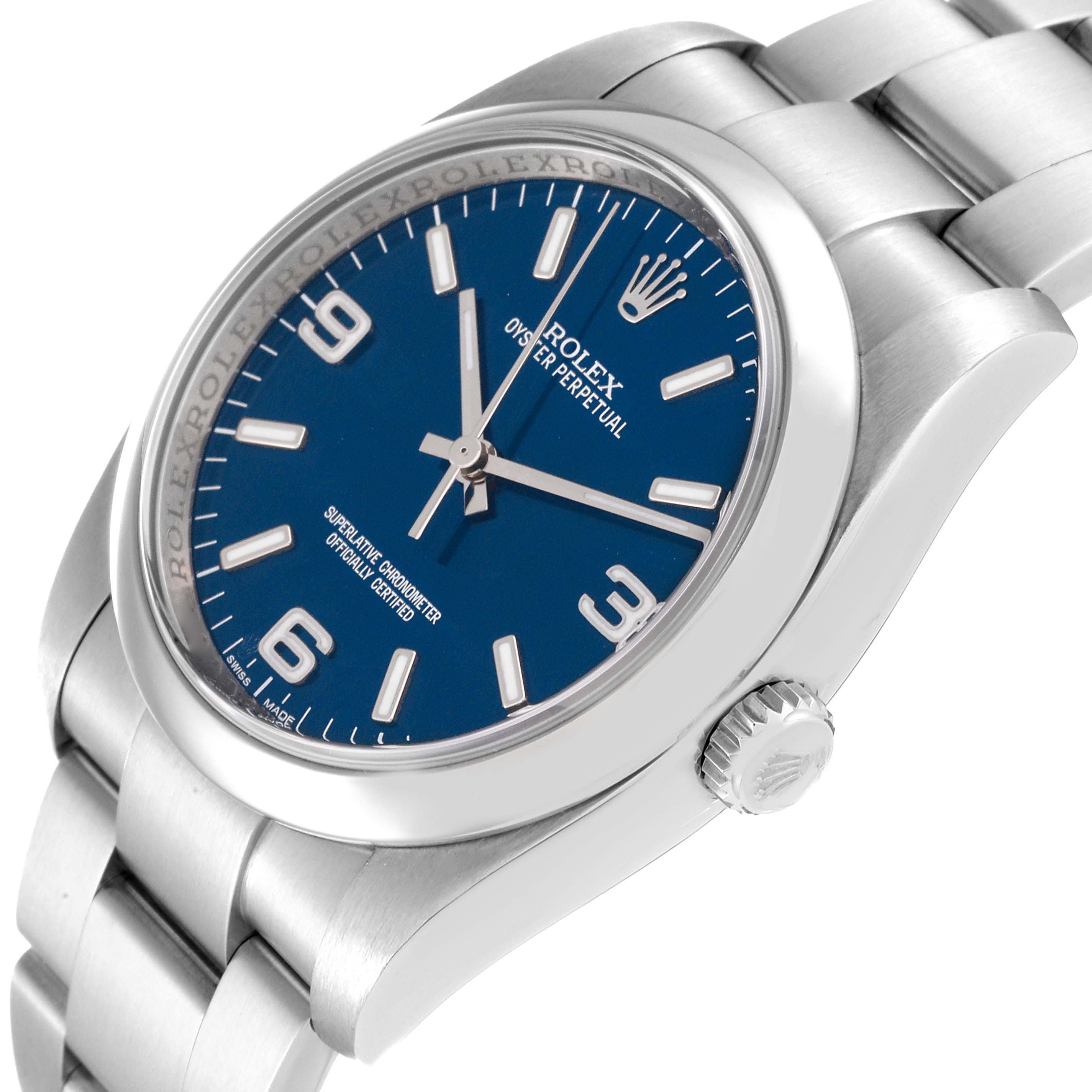 The image shows the Rolex Oyster Perpetual 116000 Men
s Stainless Steel Blue Dial 116000 Men
s Stainless Steel Blue Dial watch at a three-quarter angle, detailing the blue dial, crown, and stainless steel bracelet.