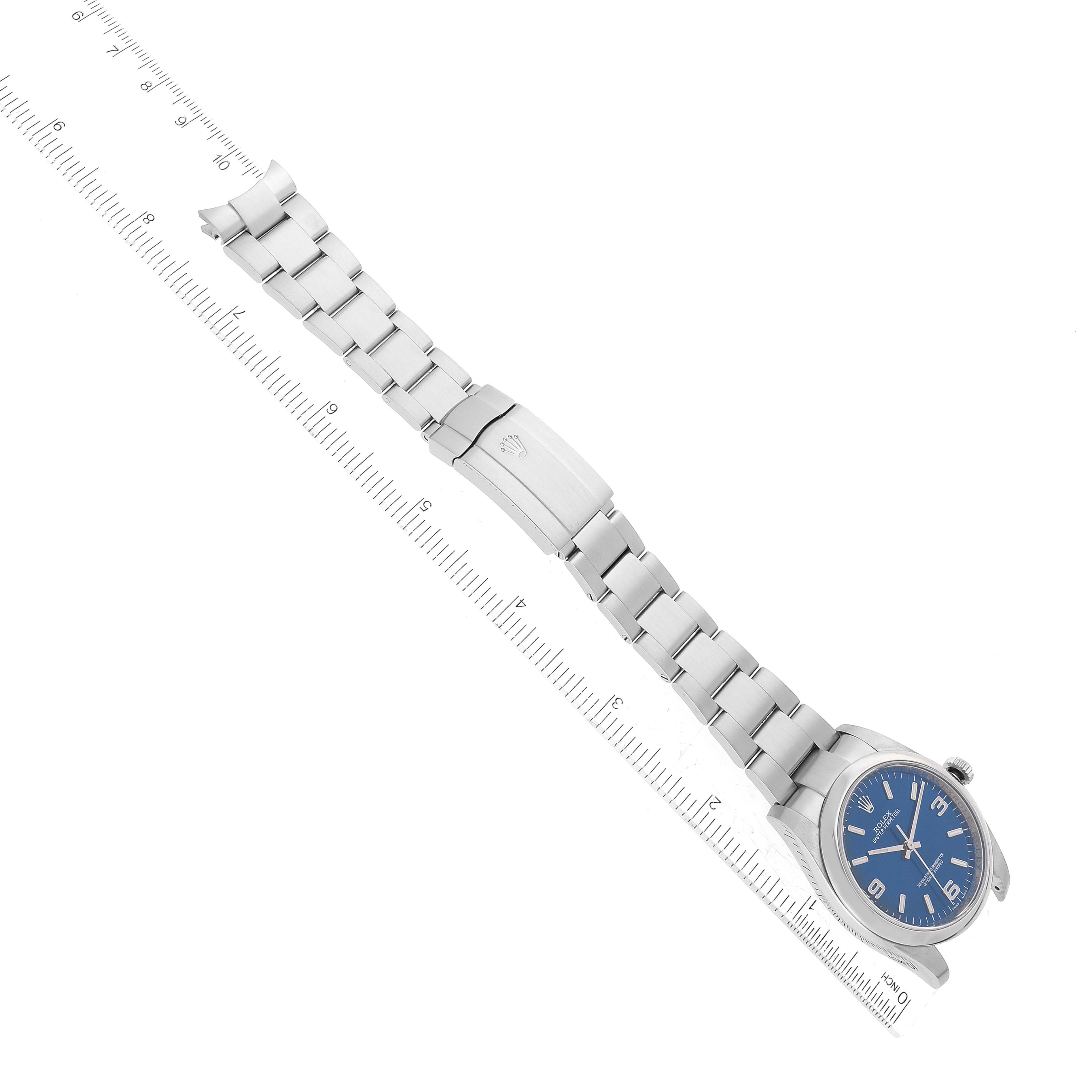 This image shows a Rolex Oyster Perpetual 116000 Men
s Stainless Steel Blue Dial 116000 Men
s Stainless Steel Blue Dial watch at an overhead angle, displaying the bracelet and clasp.