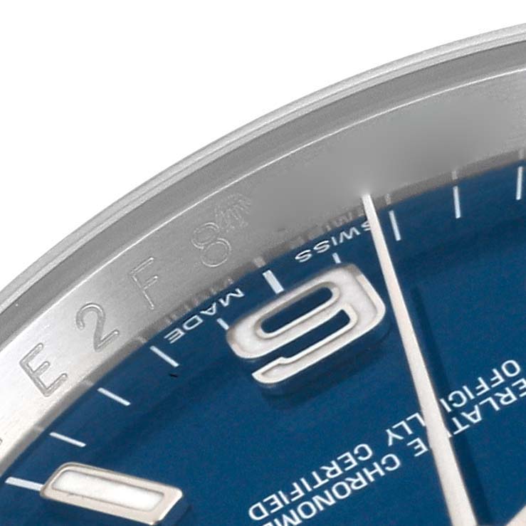This close-up shows part of the blue dial and bezel of a Rolex Oyster Perpetual 116000 Men
s Stainless Steel Blue Dial 116000 Men
s Stainless Steel Blue Dial watch.