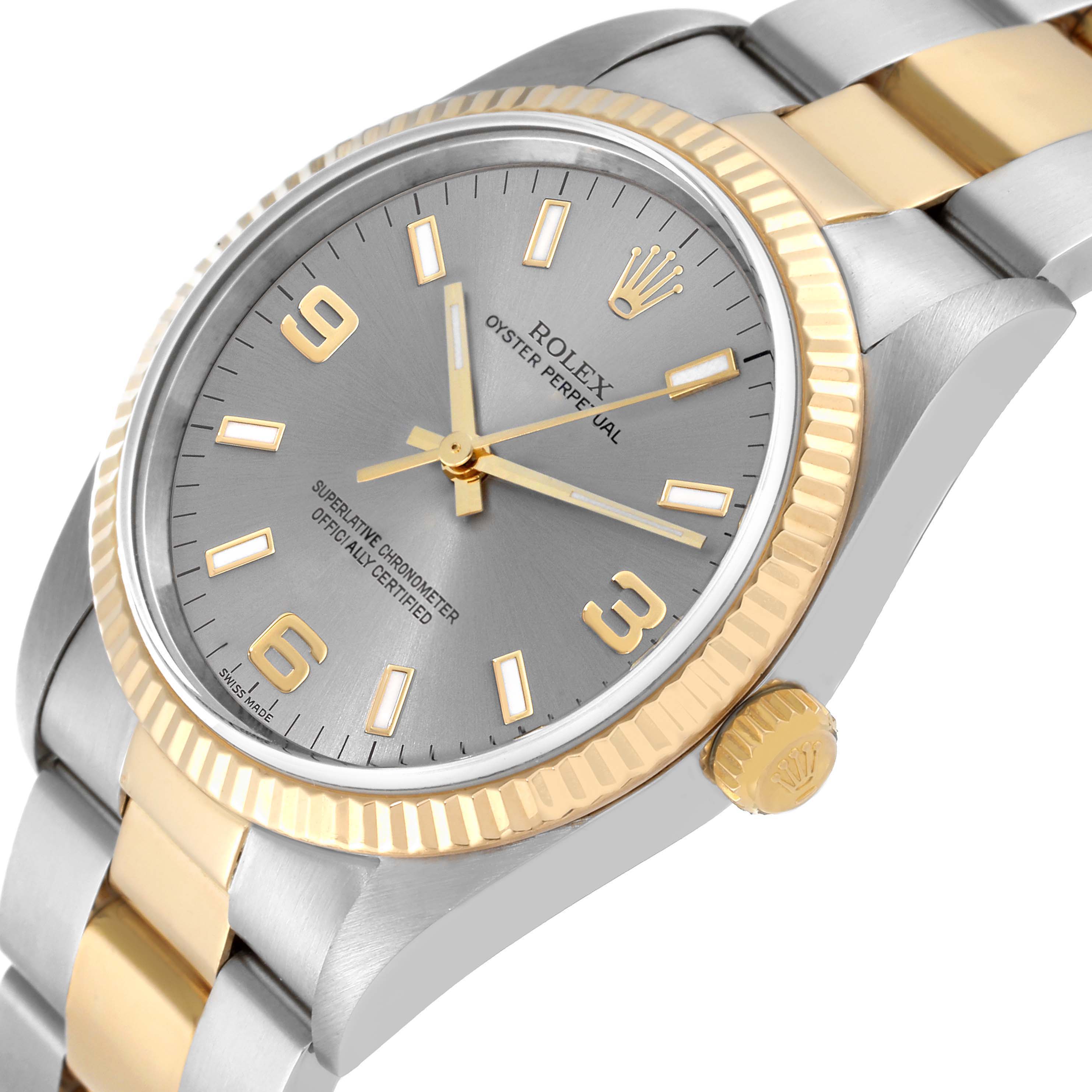 This image shows a Rolex Oyster Perpetual 14233 Men's Steel and Gold (two tone) Grey Dial 14233 Men's Steel and Gold (two tone) Grey Dial watch at an oblique angle, focusing on the dial, bezel, and part of the bracelet.