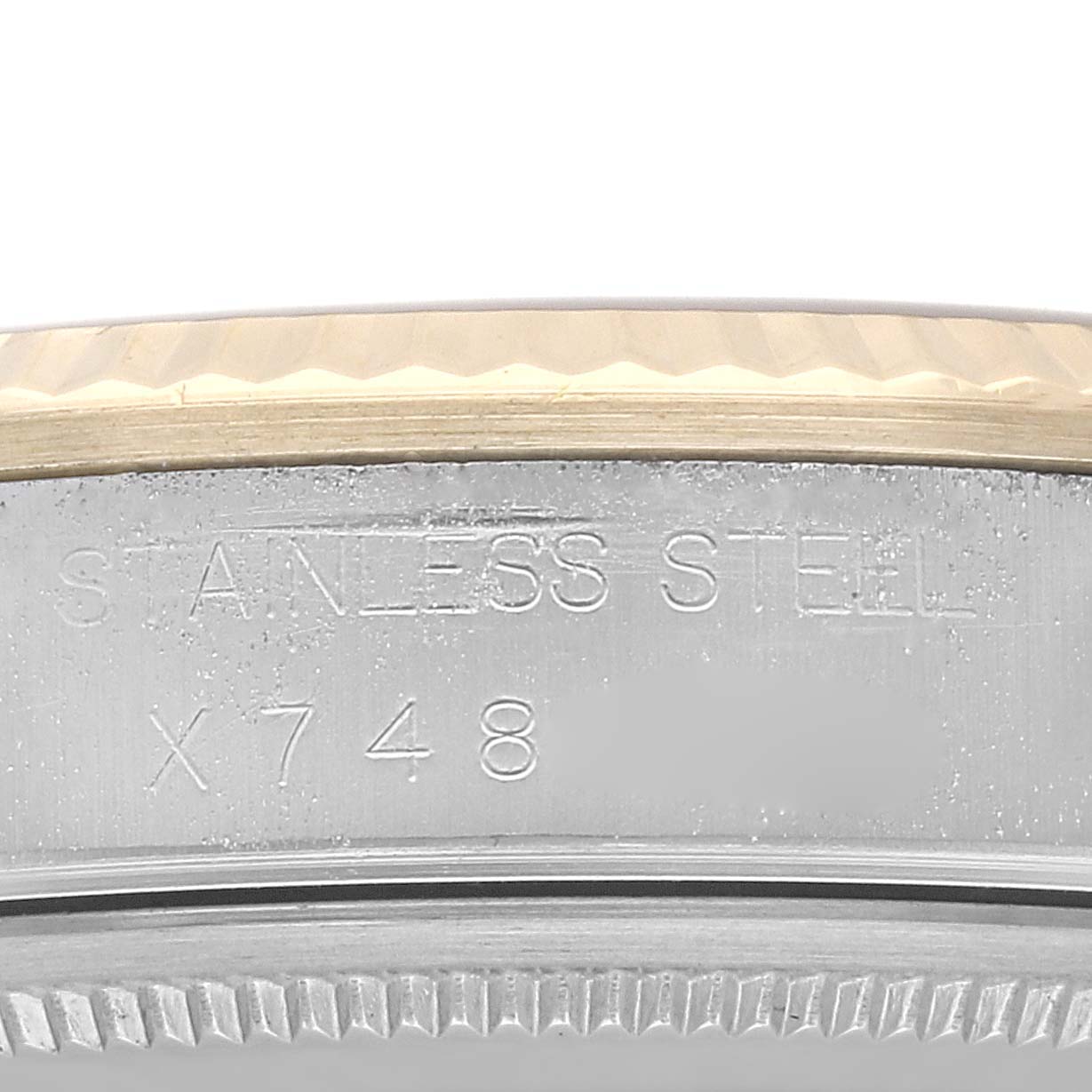 This image shows a close-up view of the side casing with "STAINLESS STEEL" and a serial number engraved on a Rolex Oyster Perpetual 14233 Men's Steel and Gold (two tone) Grey Dial 14233 Men's Steel and Gold (two tone) Grey Dial watch.