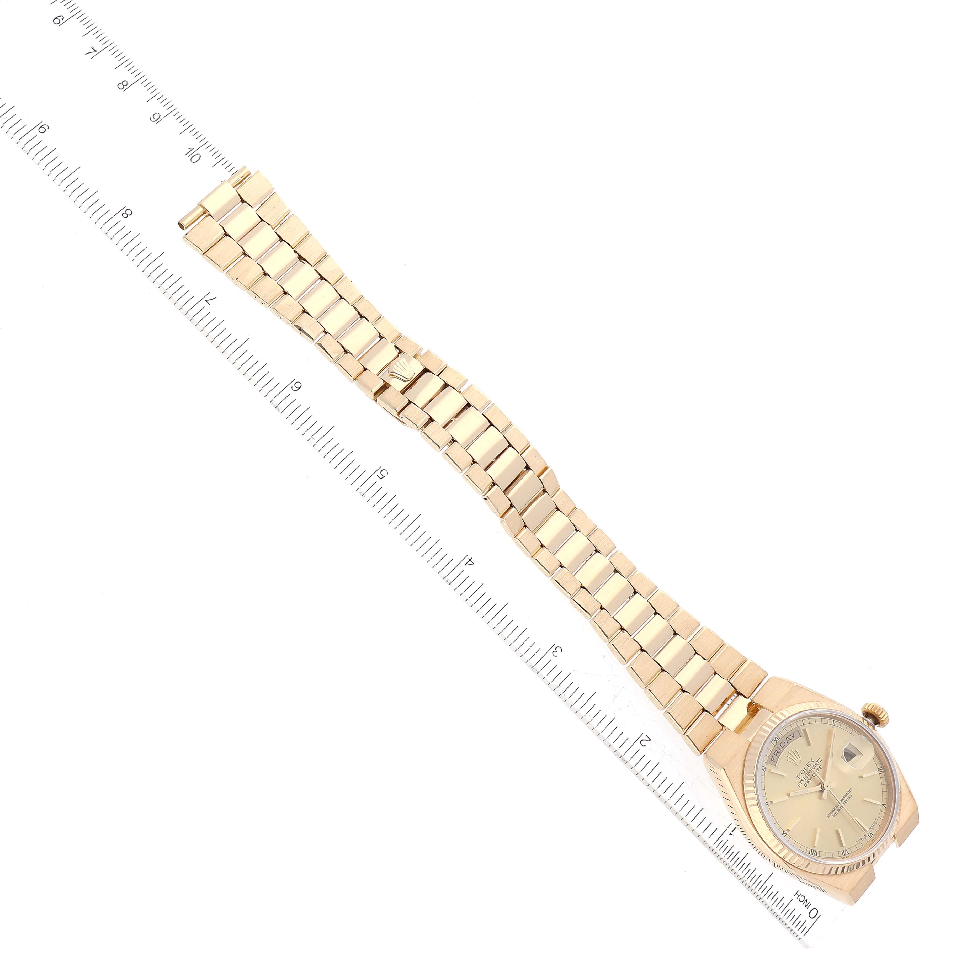 The Rolex Oysterquartz 19018 Men's Yellow Gold Champagne Dial 19018 Men's Yellow Gold Champagne Dial watch is shown flat with its face and entire gold-link bracelet visible, positioned alongside a ruler for scale.