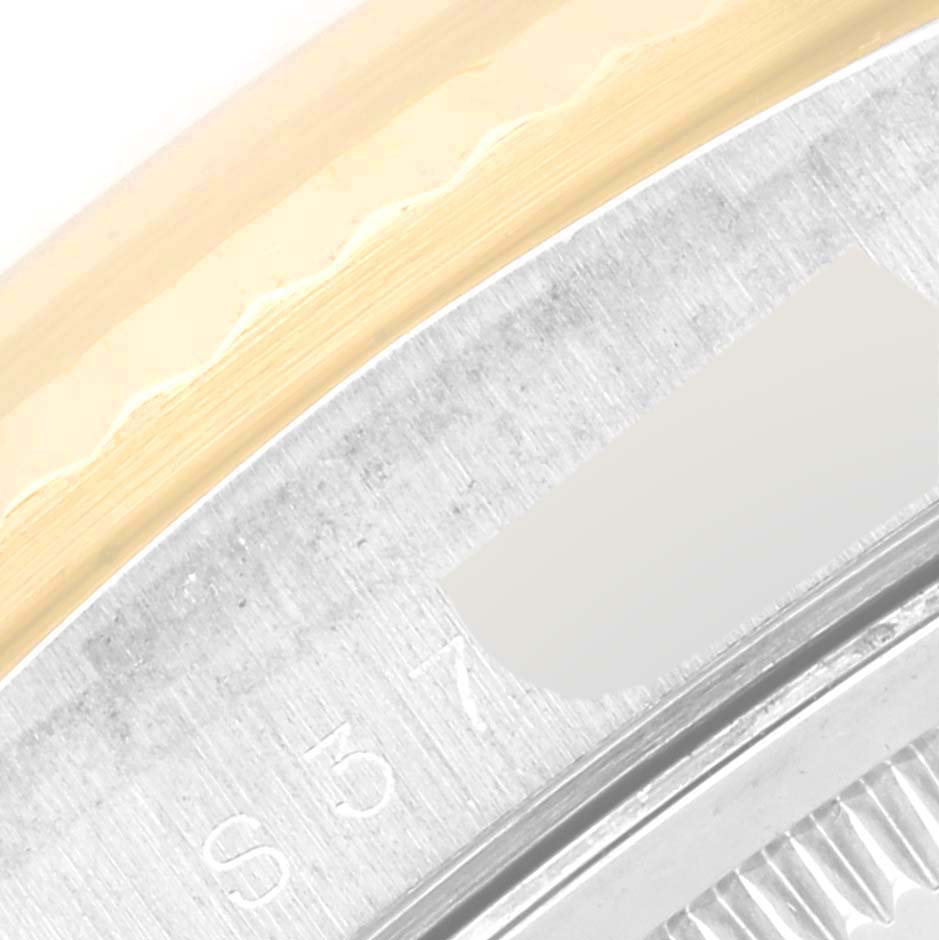 This image shows an extreme close-up of the bezel and part of the case of a Rolex President 18239BIC Men's White Gold Silver Dial 18239BIC Men's White Gold Silver Dial model watch.