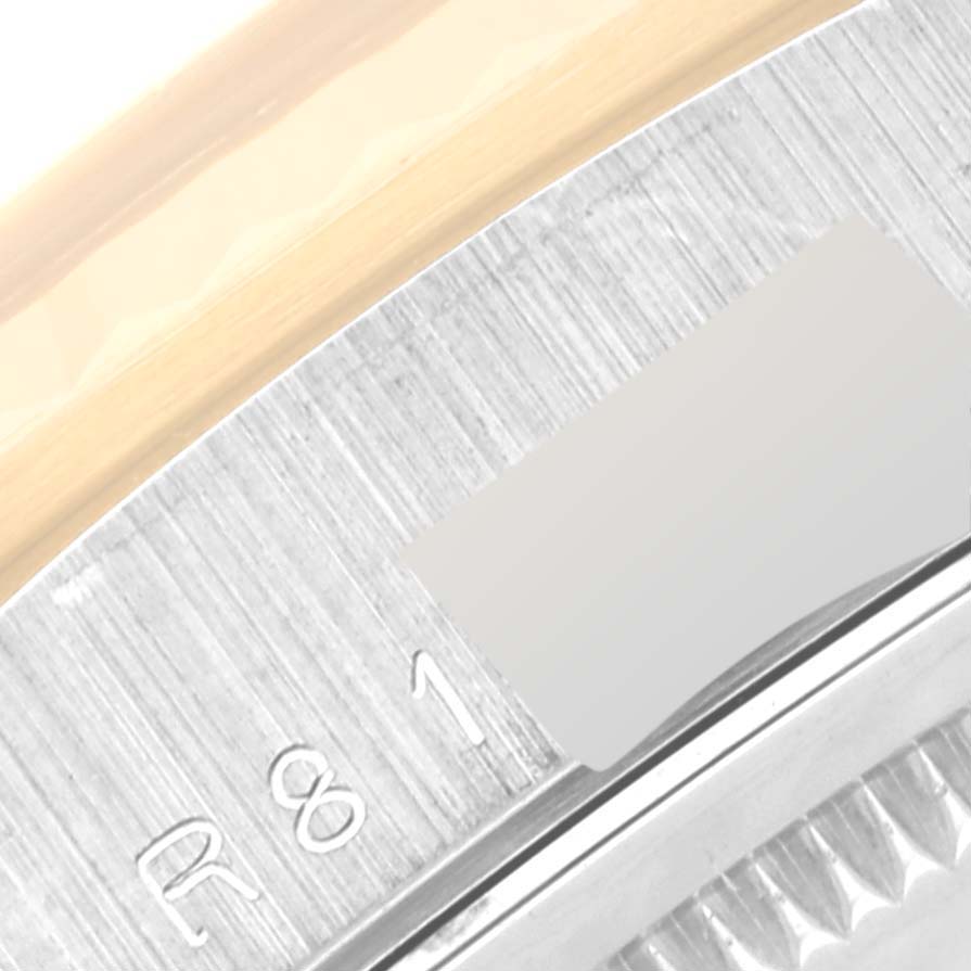 This close-up angle of the Rolex President 18239 Men's White Gold Champagne Dial 18239 Men's White Gold Champagne Dial model watch shows part of the bezel and a portion of the rehaut with engraved markings.