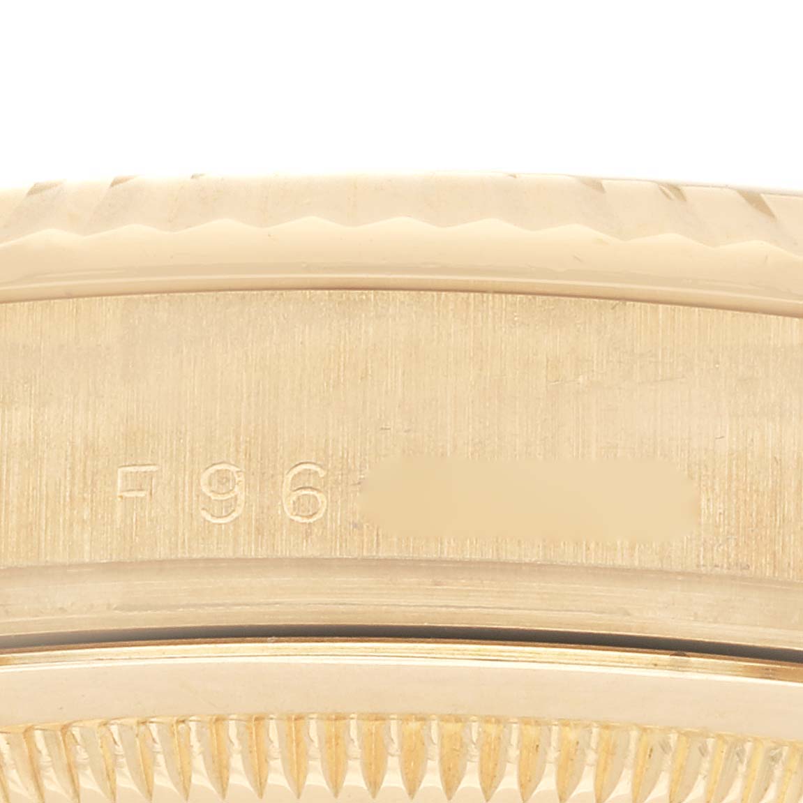 This close-up image shows the side and possibly the serial number of the Rolex President 118238 Men's Yellow Gold Black Dial 118238 Men's Yellow Gold Black Dial model watch.