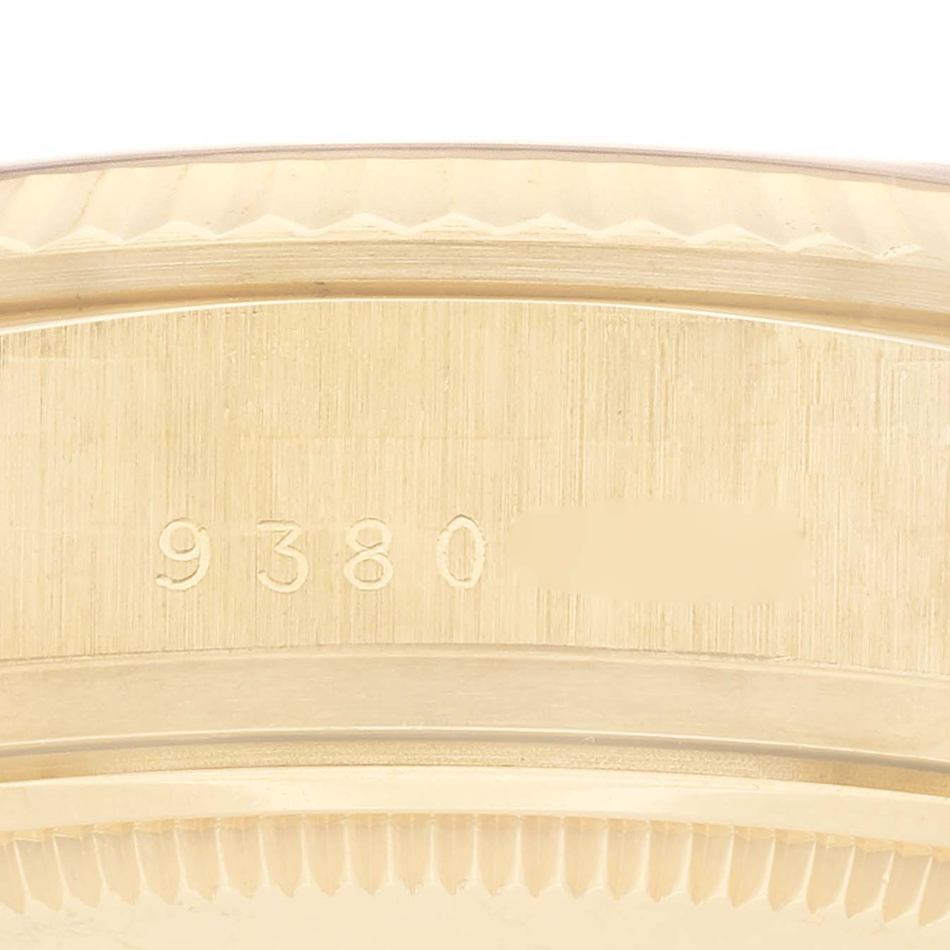 This close-up image shows the side of the case and bezel of a Rolex President 18038 Men
s Yellow Gold Champagne Dial 18038 Men
s Yellow Gold Champagne Dial model, featuring serial numbers.