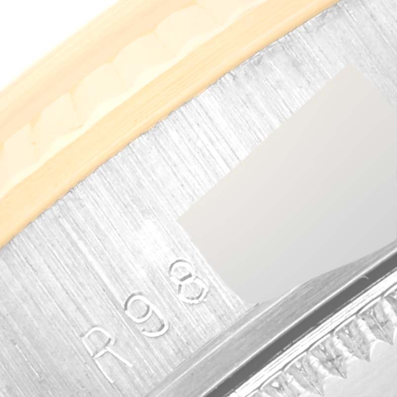 This is a close-up view of the Rolex President 68279 Women's White Gold Black Dial 68279 Women's White Gold Black Dial model, showing parts of the bezel and dial edge with some engraved markings.