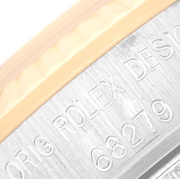 This image shows a close-up of the engraved model number and part of the bezel of a Rolex President 68279 Women's White Gold Black Dial 68279 Women's White Gold Black Dial watch.
