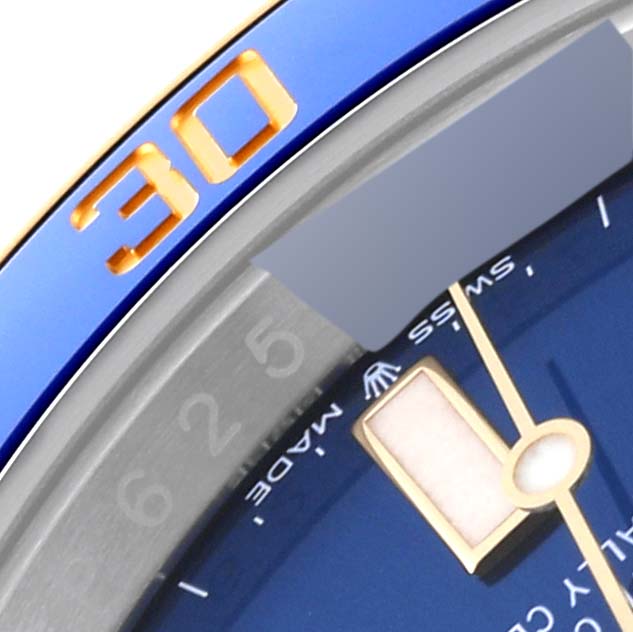 The image shows a close-up of the bezel and part of the dial of a Rolex Submariner 126613LB Men's Steel and Gold (two tone) Blue Dial 126613LB Men's Steel and Gold (two tone) Blue Dial watch, highlighting the "30" minute marker.