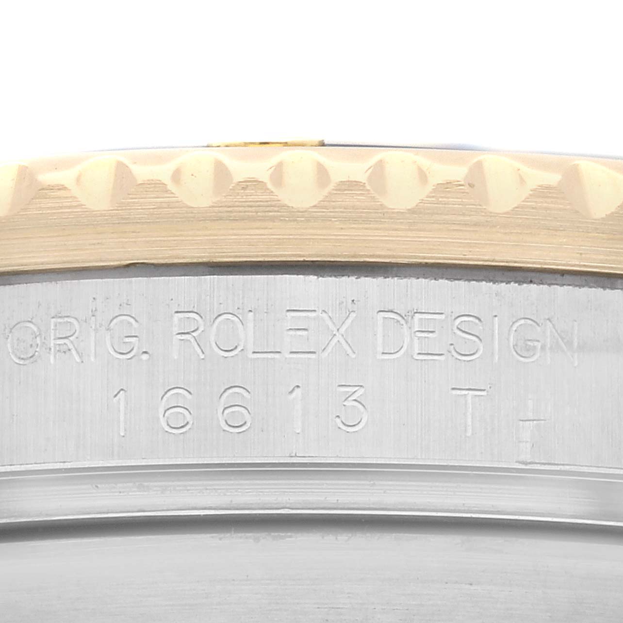 This image shows the engraved case side and part of the bezel of a Rolex Submariner 16613 Men
s Steel and Gold (two tone) Grey Dial 16613 Men
s Steel and Gold (two tone) Grey Dial model.
