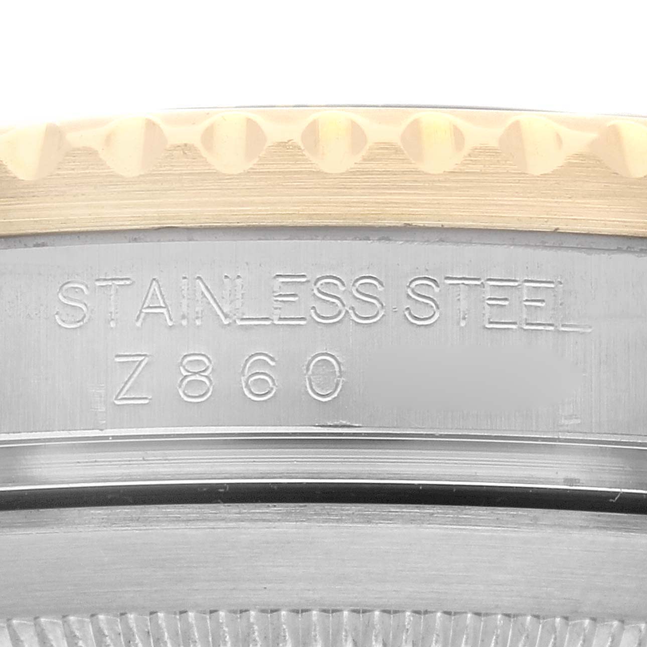 The image shows a close-up angled view of the stainless steel back and part of the bezel of a Rolex Submariner 16613 Men
s Steel and Gold (two tone) Grey Dial 16613 Men
s Steel and Gold (two tone) Grey Dial watch.