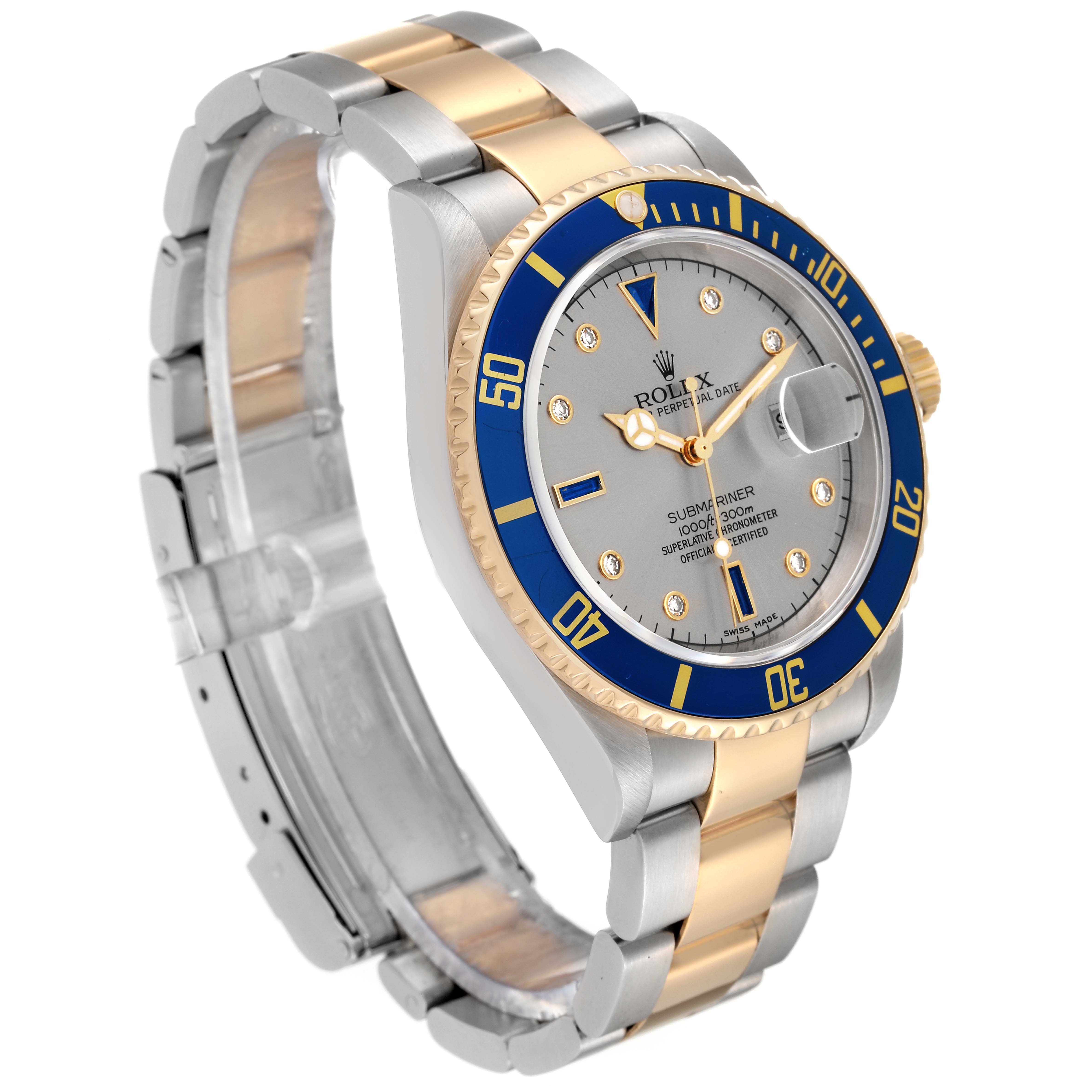 The image shows a Rolex Submariner 16613 Men
s Steel and Gold (two tone) Grey Dial 16613 Men
s Steel and Gold (two tone) Grey Dial watch at a three-quarter angle, highlighting its two-tone bracelet, blue bezel, and silver dial.