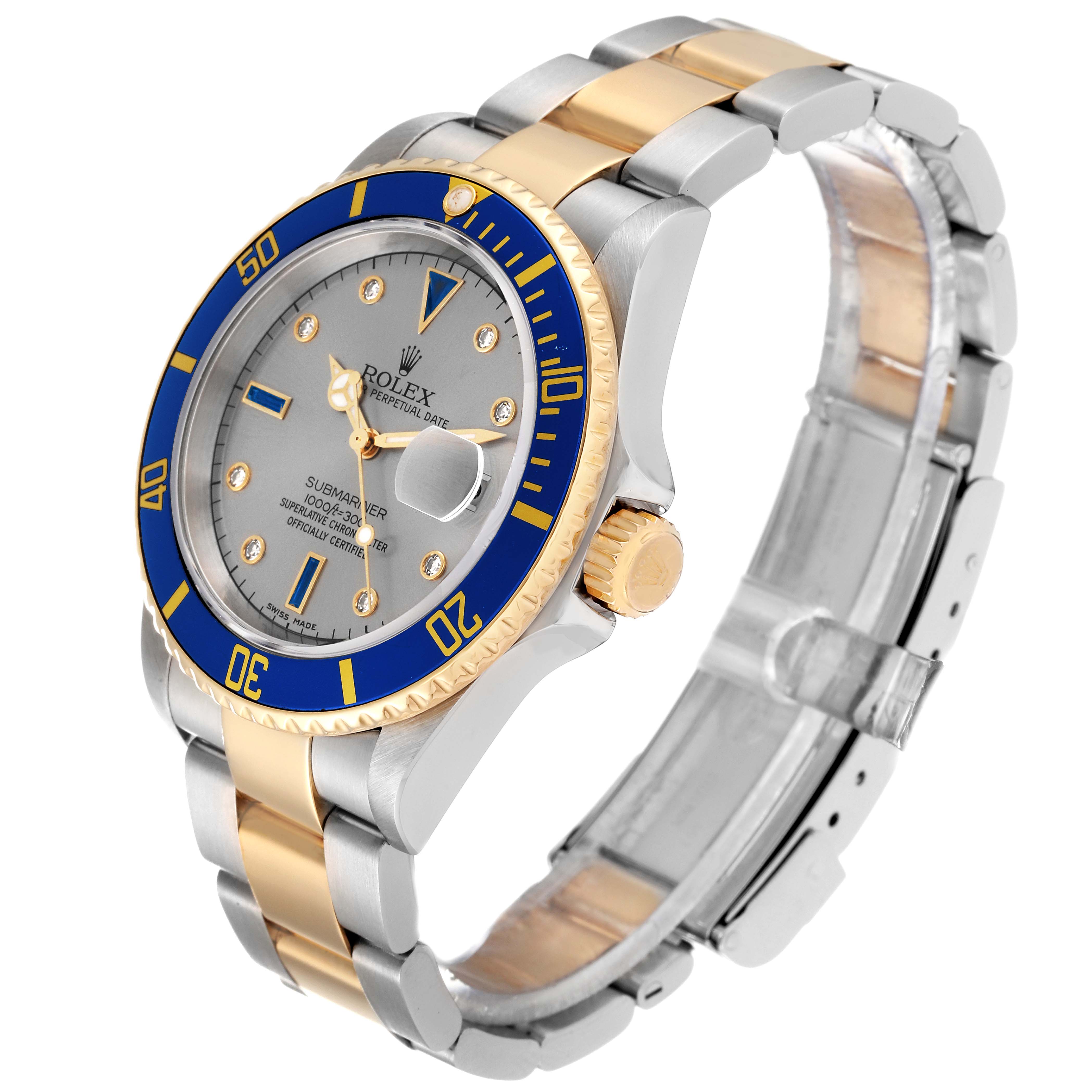 The image shows a Rolex Submariner 16613 Men
s Steel and Gold (two tone) Grey Dial 16613 Men
s Steel and Gold (two tone) Grey Dial watch at a three-quarter angle, highlighting its blue bezel, silver dial, and two-tone bracelet.