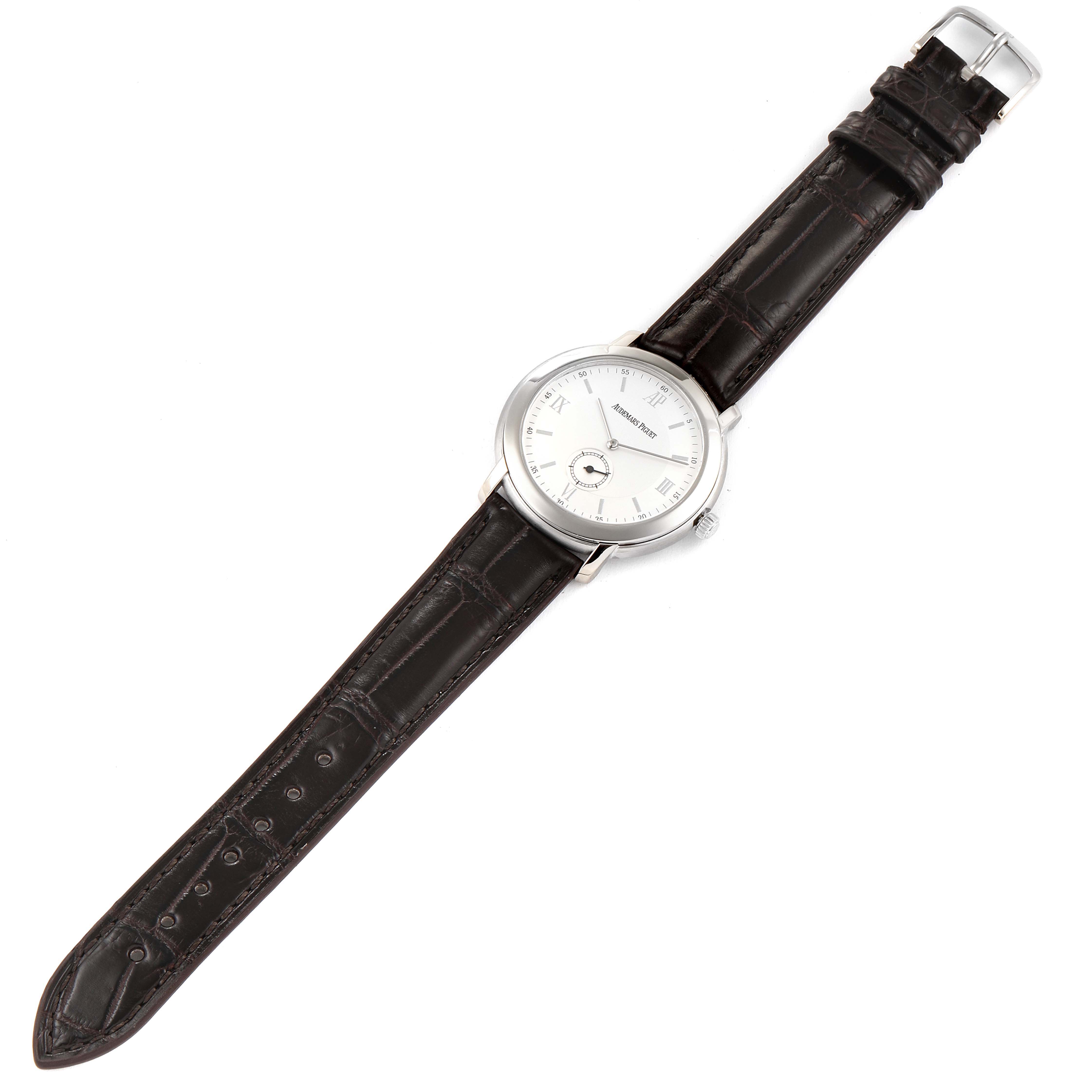 The Jules model by Audemars Piguet is shown from a top-down angle, displaying its silver dial, leather strap, and buckle.