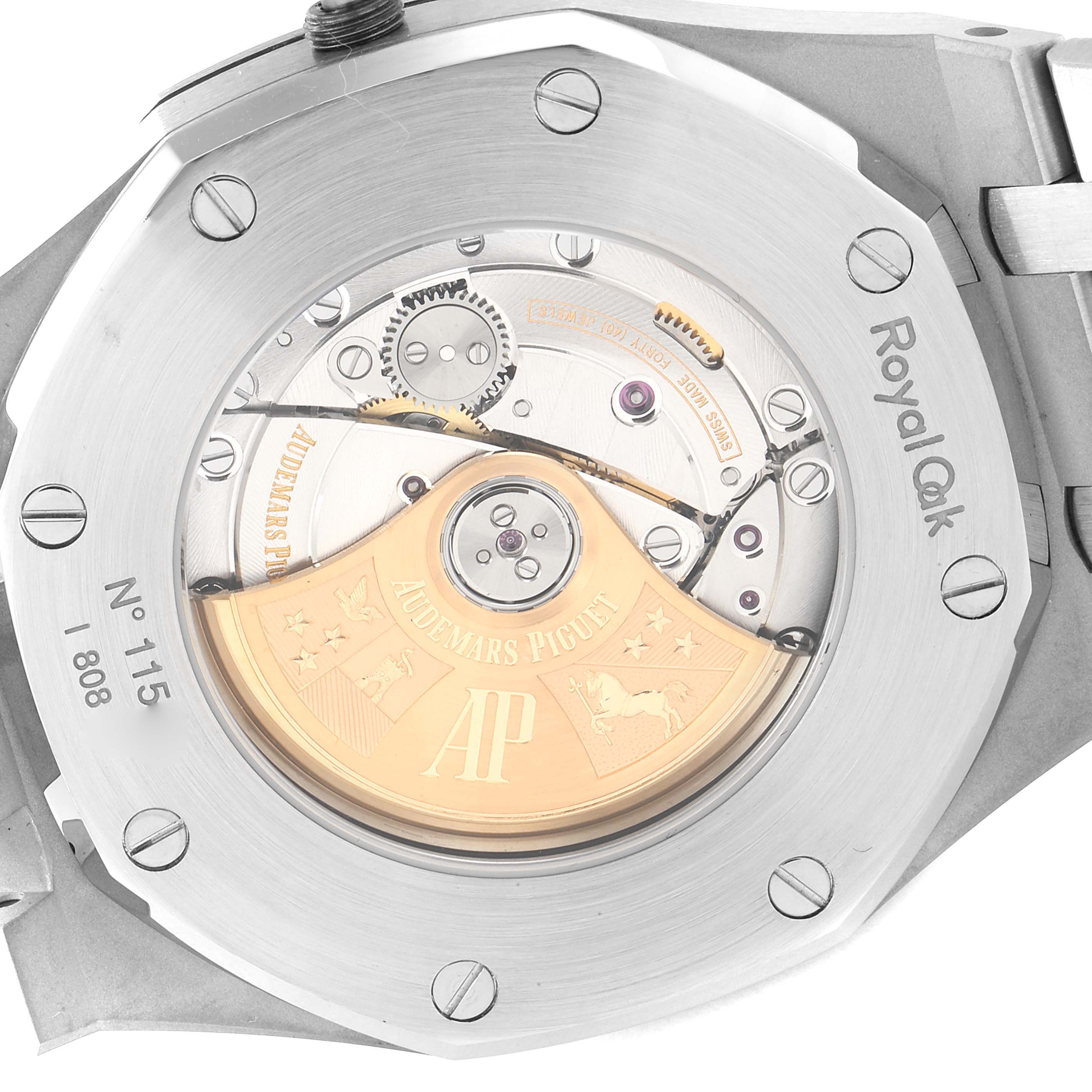 The image shows the back view of a Royal Oak watch by Audemars Piguet, highlighting the mechanical movement and brand engravings.