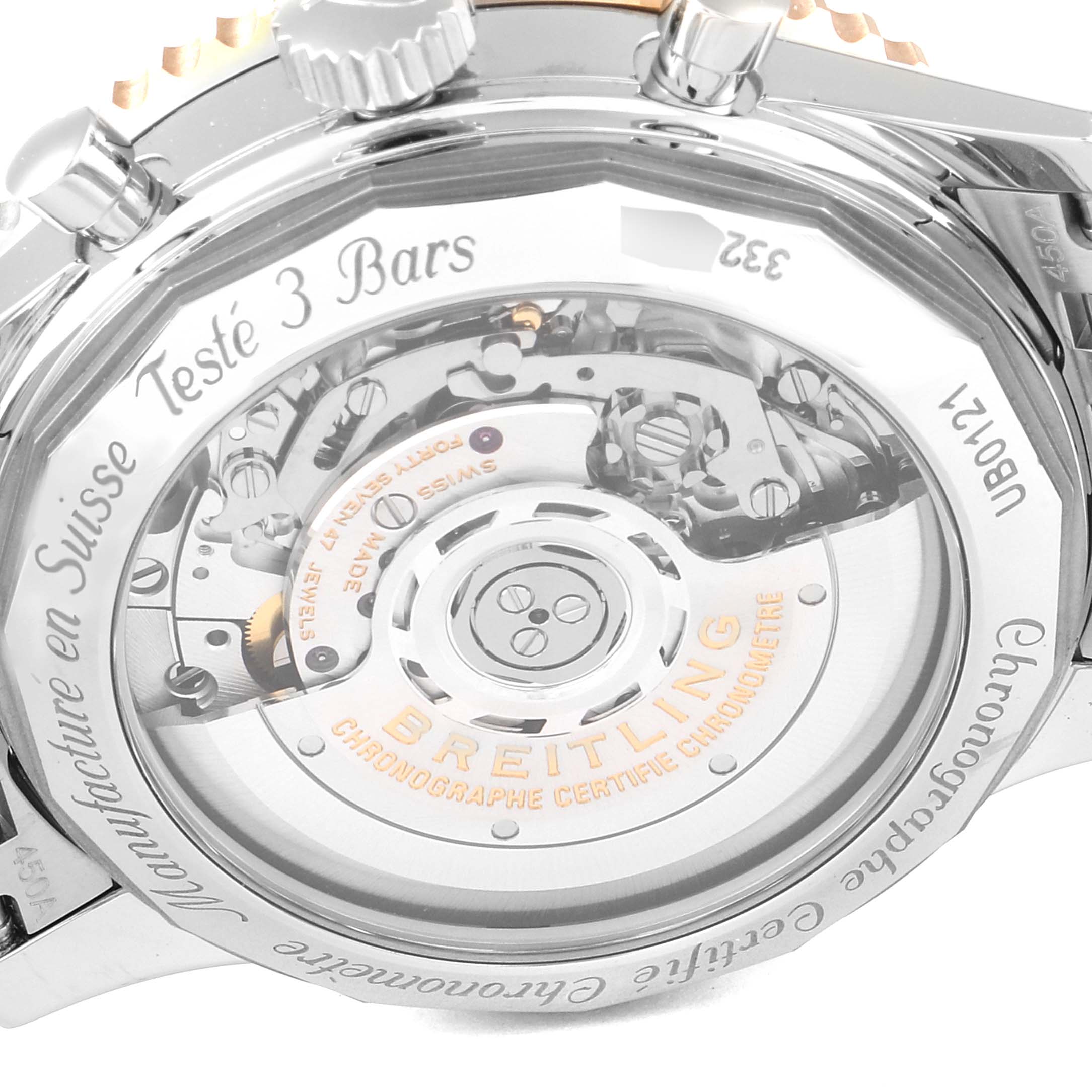 The image shows the back case of the Breitling Navitimer UB0121 Men's Steel and Gold (two tone) Grey Dial UB0121 Men's Steel and Gold (two tone) Grey Dial watch, focusing on its exposed mechanical movement and engravings.