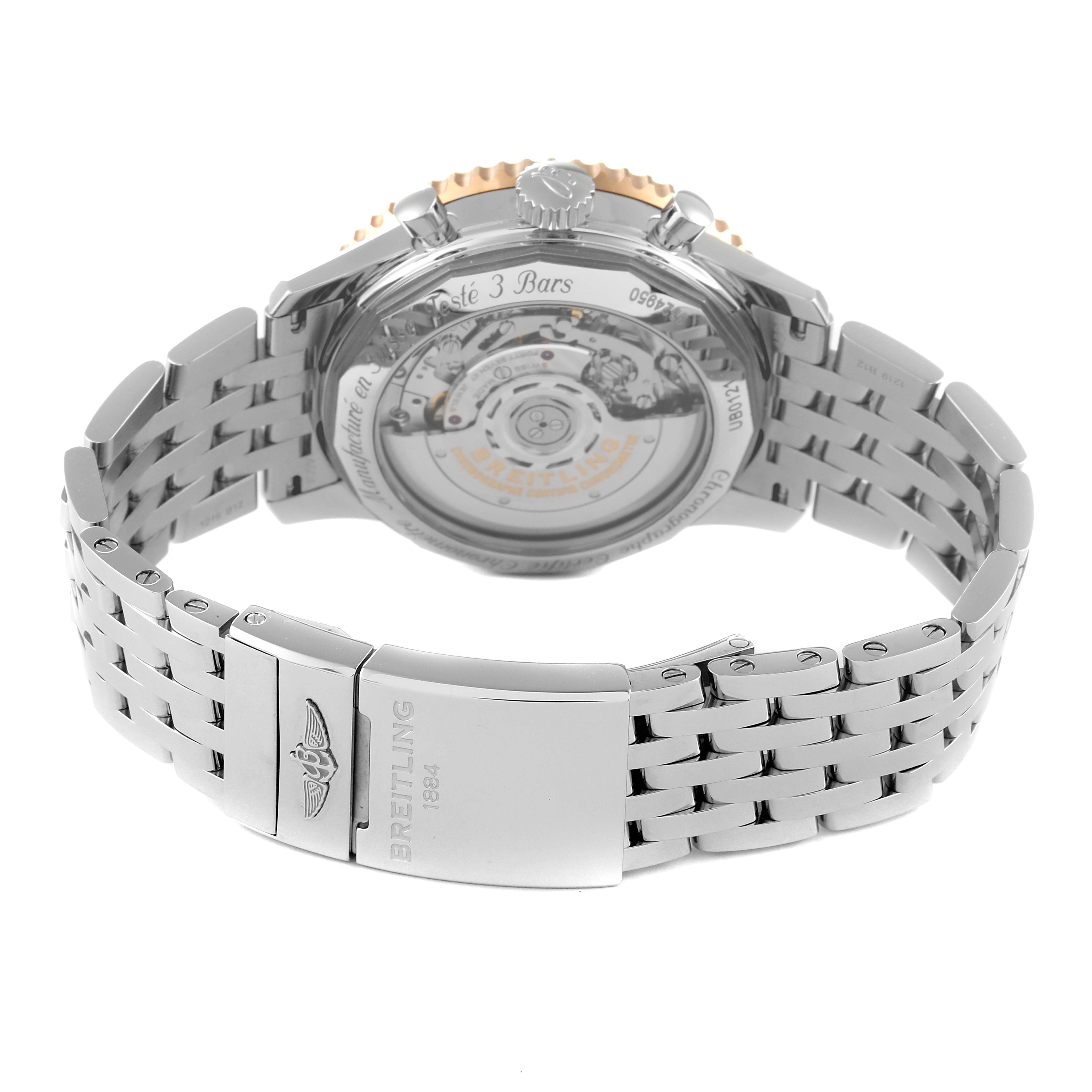 The image shows the back view of the Breitling Navitimer UB0121 Men's Steel and Gold (two tone) Grey Dial UB0121 Men's Steel and Gold (two tone) Grey Dial, revealing its transparent case back and metal bracelet clasp.