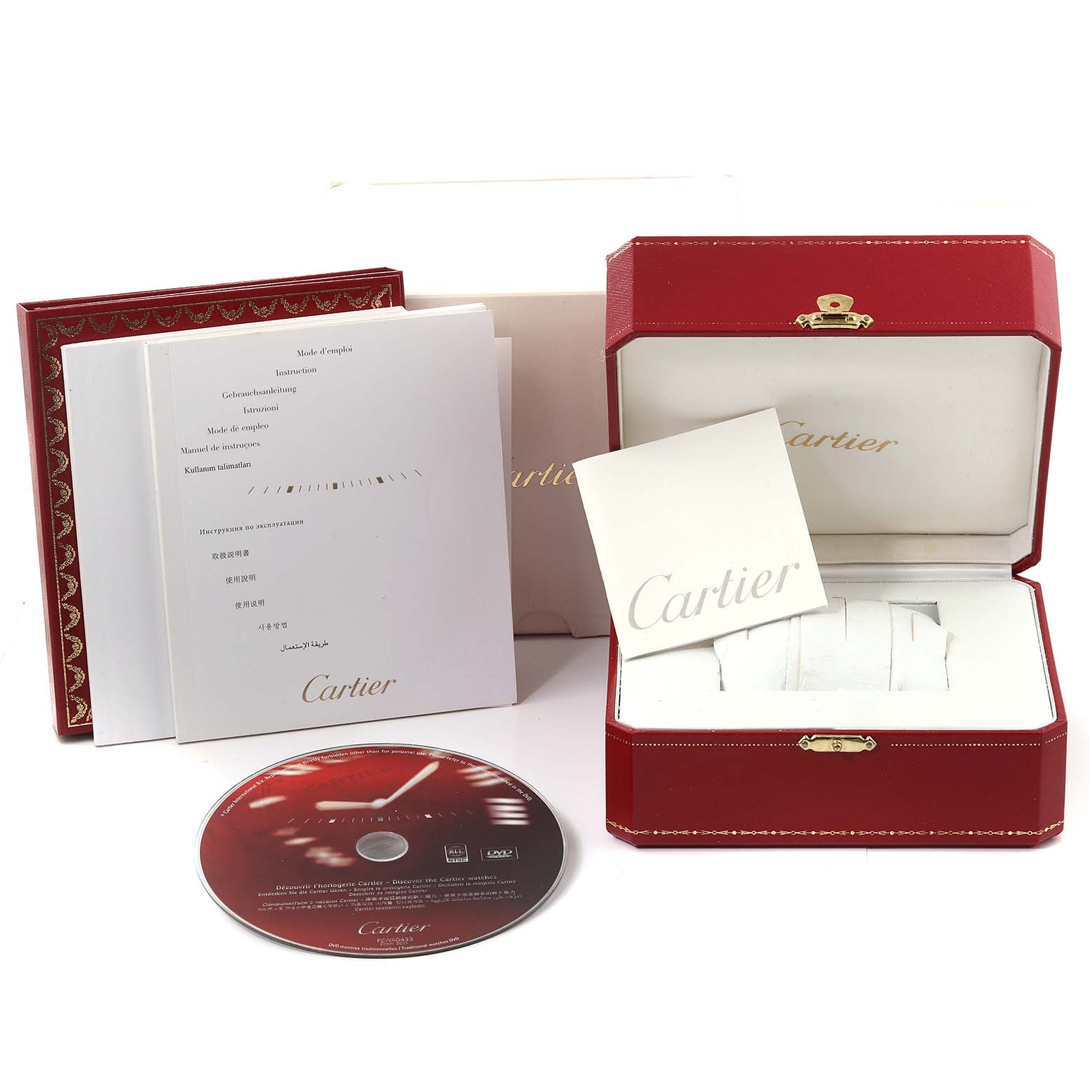 The image shows packaging, manuals, and accessories for a Calibre de Cartier watch by Cartier, including a box and CD.