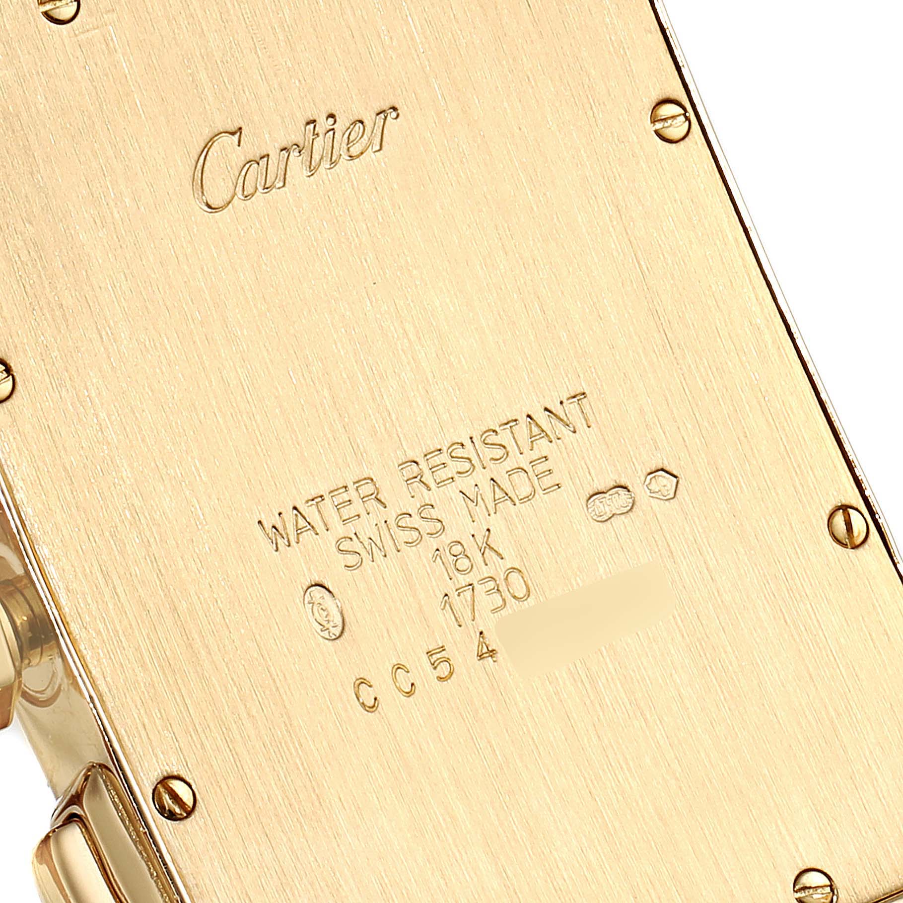This image shows the back of a Cartier Tank Americaine W2601156 Men's Yellow Gold Silver Dial W2601156 Men's Yellow Gold Silver Dial watch, highlighting the 18K gold and water resistance markings.