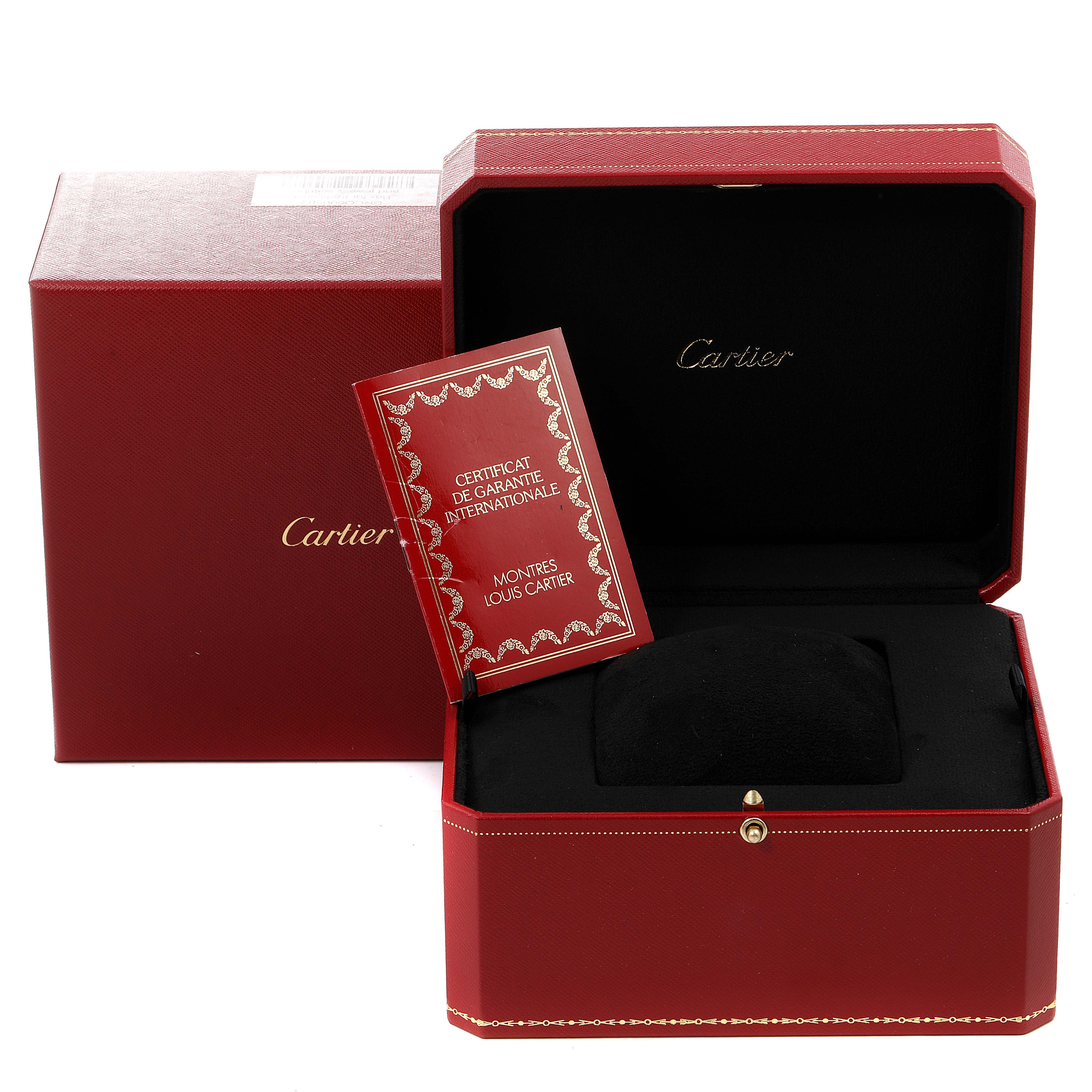 The image shows the packaging box and Certificate de Garantie Internationale for a Cartier Tank Américaine model watch.