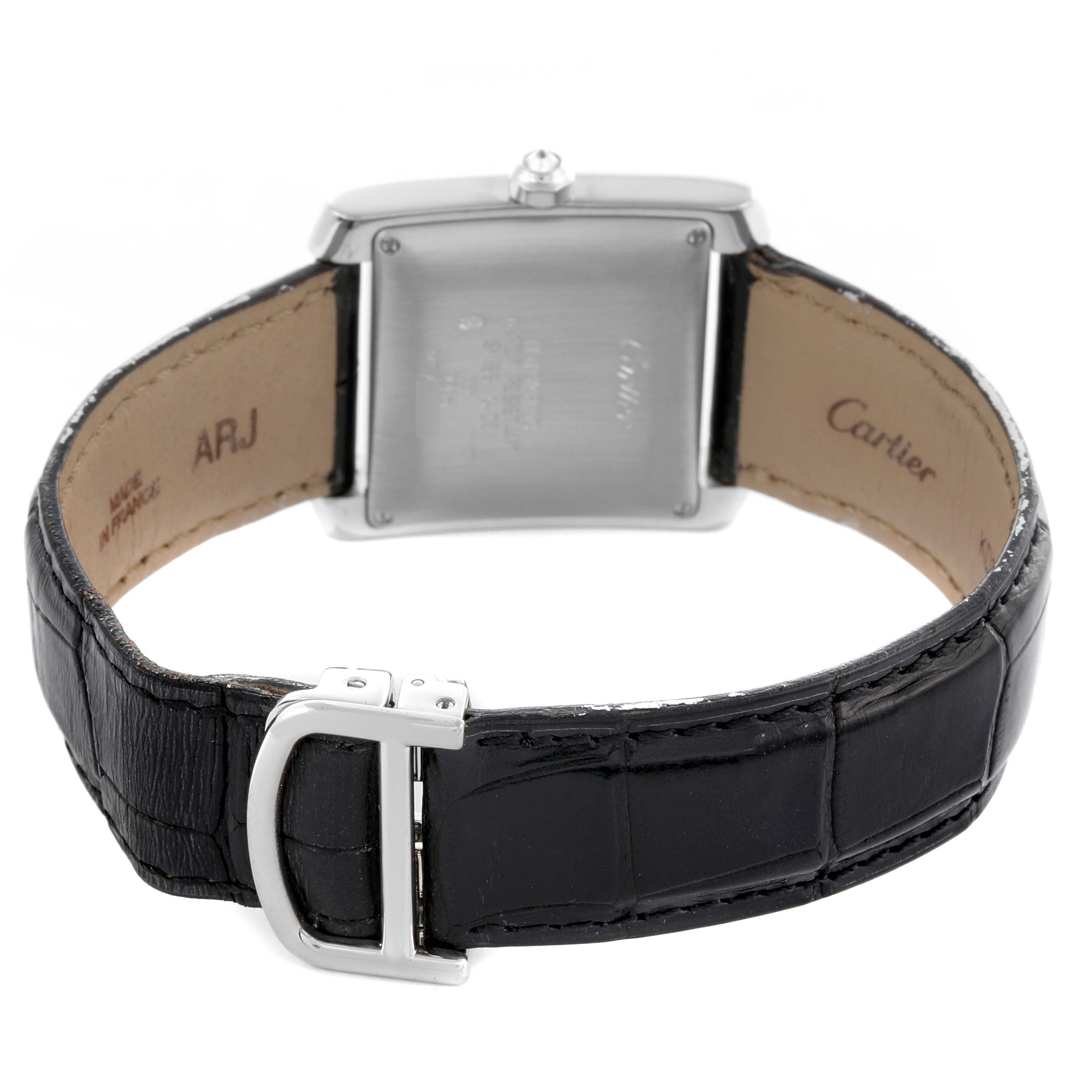 The Cartier Tank Française watch is shown from the back, highlighting the case, strap, and clasp.