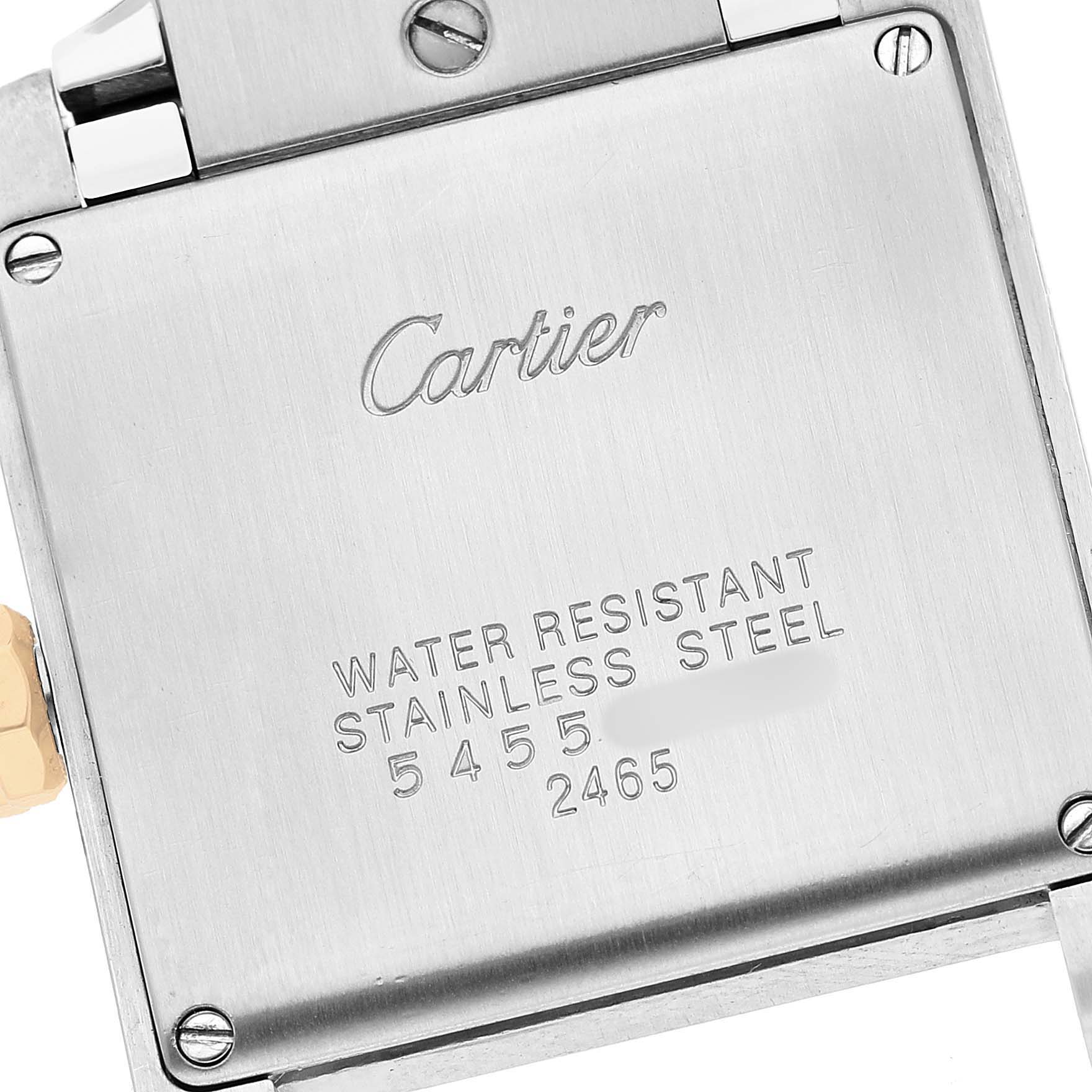 The image shows the back case of a Cartier Tank Française watch, featuring engravings and screw details.