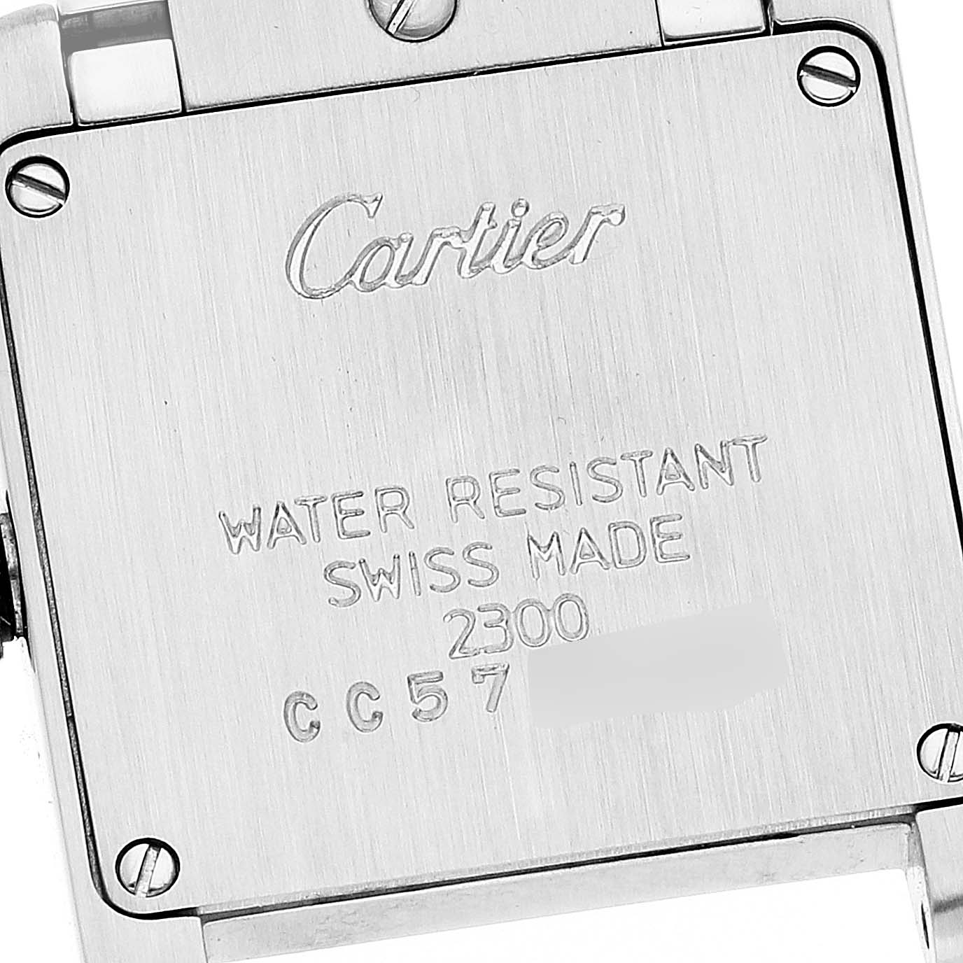 The image shows the back case of a Cartier Tank Française watch, highlighting the engravings and screws.