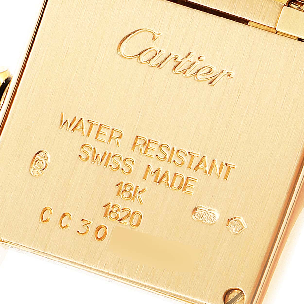 The image shows the back casing of a Cartier Tank Francaise W50002N2 Women
s Yellow Gold Silver Dial W50002N2 Women
s Yellow Gold Silver Dial watch with engraved details about material and water resistance.