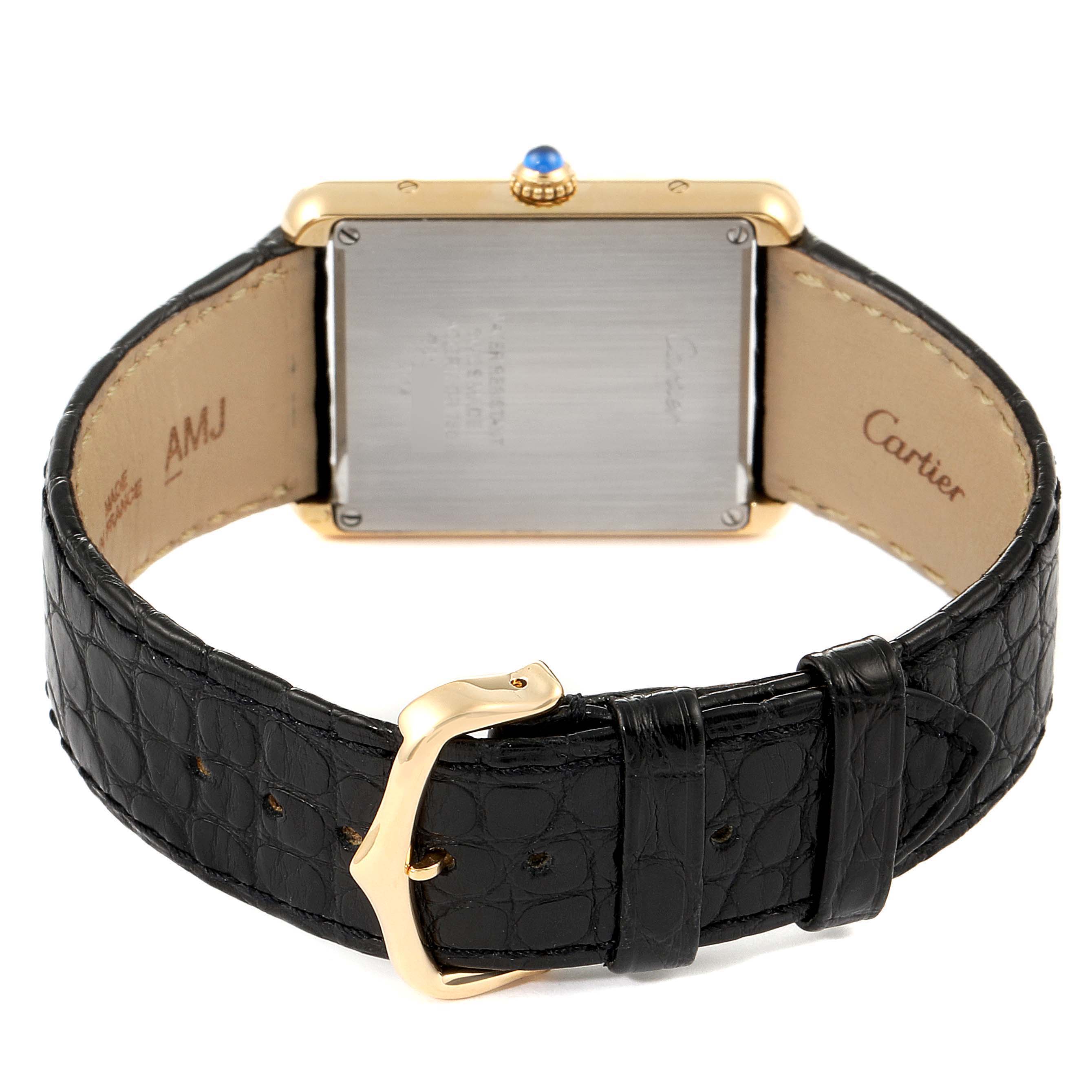 This image shows the back of the Cartier Tank Solo W1018855 Men's Yellow Gold Silver Dial W1018855 Men's Yellow Gold Silver Dial watch, focusing on the leather strap and the case back.