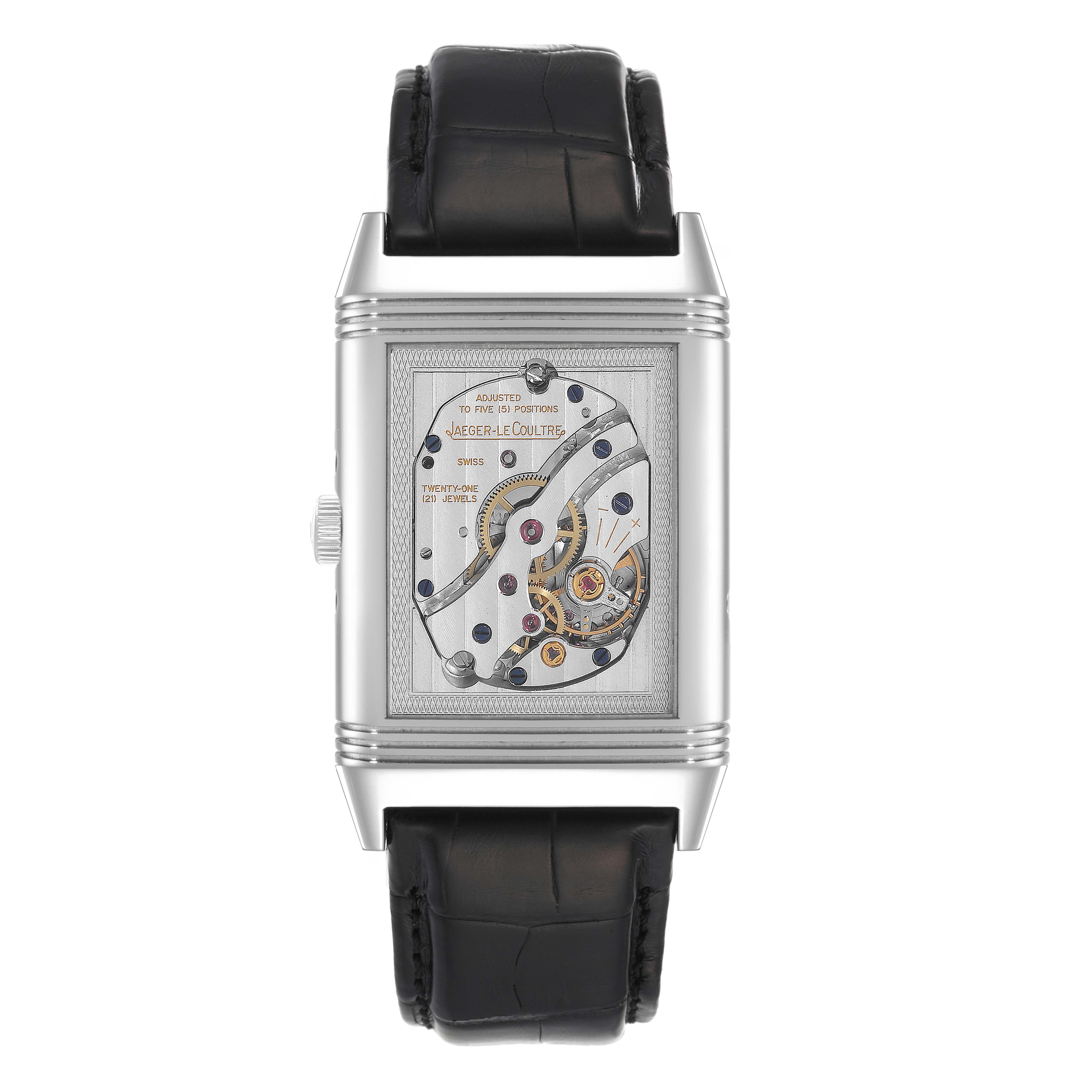 The image shows a Jaeger-LeCoultre Reverso watch from a front angle, highlighting the watch's intricate inner workings.