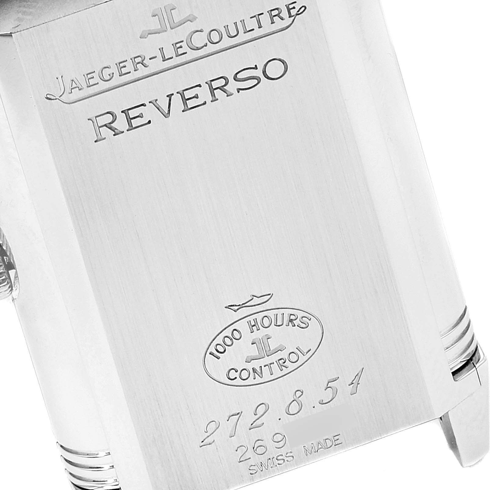 This image shows the back case of a Jaeger-LeCoultre Reverso watch, highlighting the brand, model name, and quality control mark.