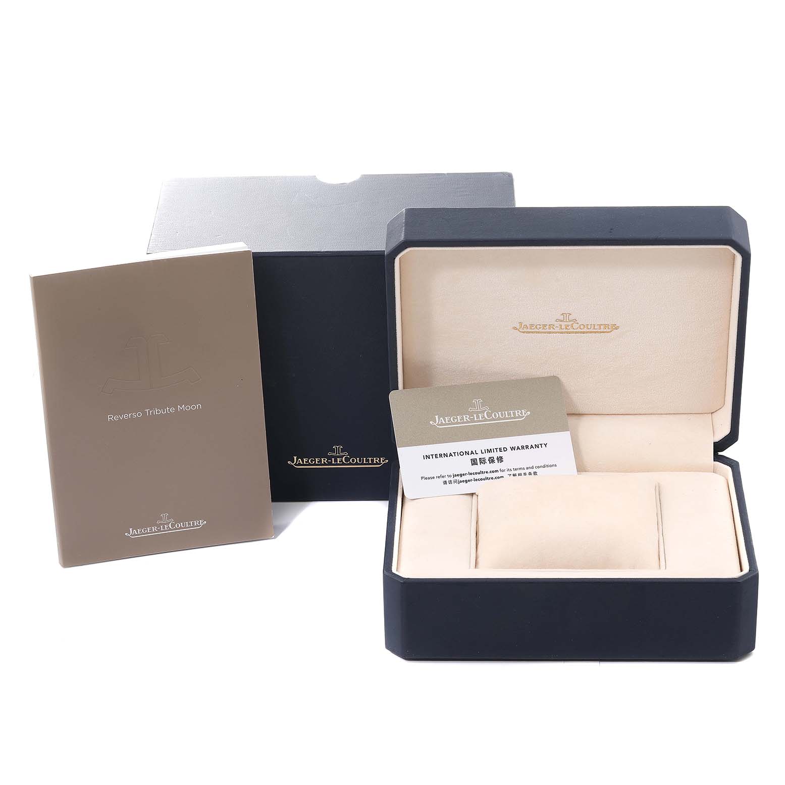 The image shows the packaging and accessories for a Jaeger-LeCoultre Reverso watch, including the box, manual, and warranty card.
