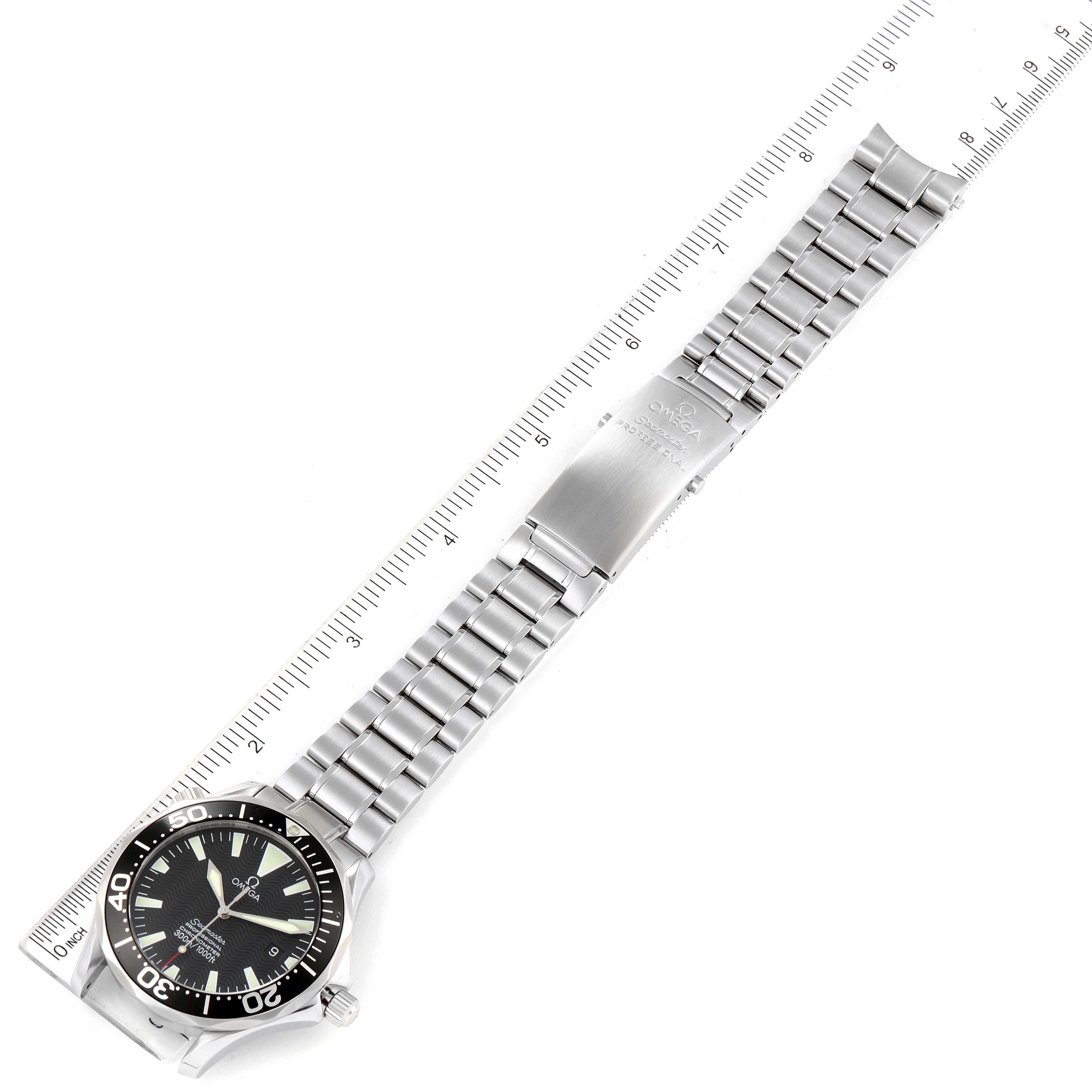 The image shows an Omega Seamaster 2254.50.00 Men's Stainless Steel Black Dial 2254.50.00 Men's Stainless Steel Black Dial watch laid flat, highlighting its face, bezel, and metal bracelet strap with a ruler for scale.
