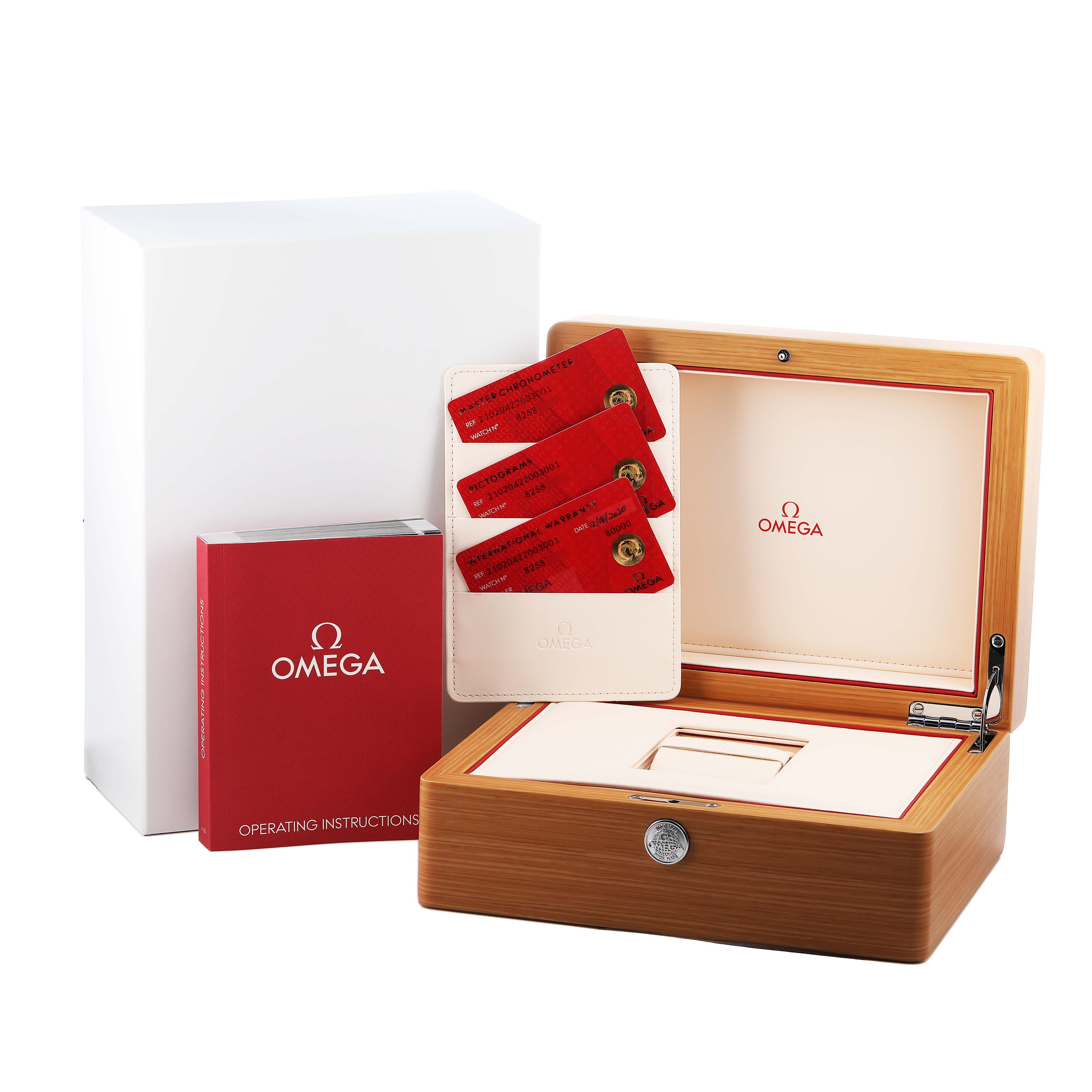 This image shows the Omega Seamaster 210.20.42.20.03.001 Men's Steel and Gold (two tone) Blue Dial packaging with an open wooden box, warranty cards, and the operating manual.