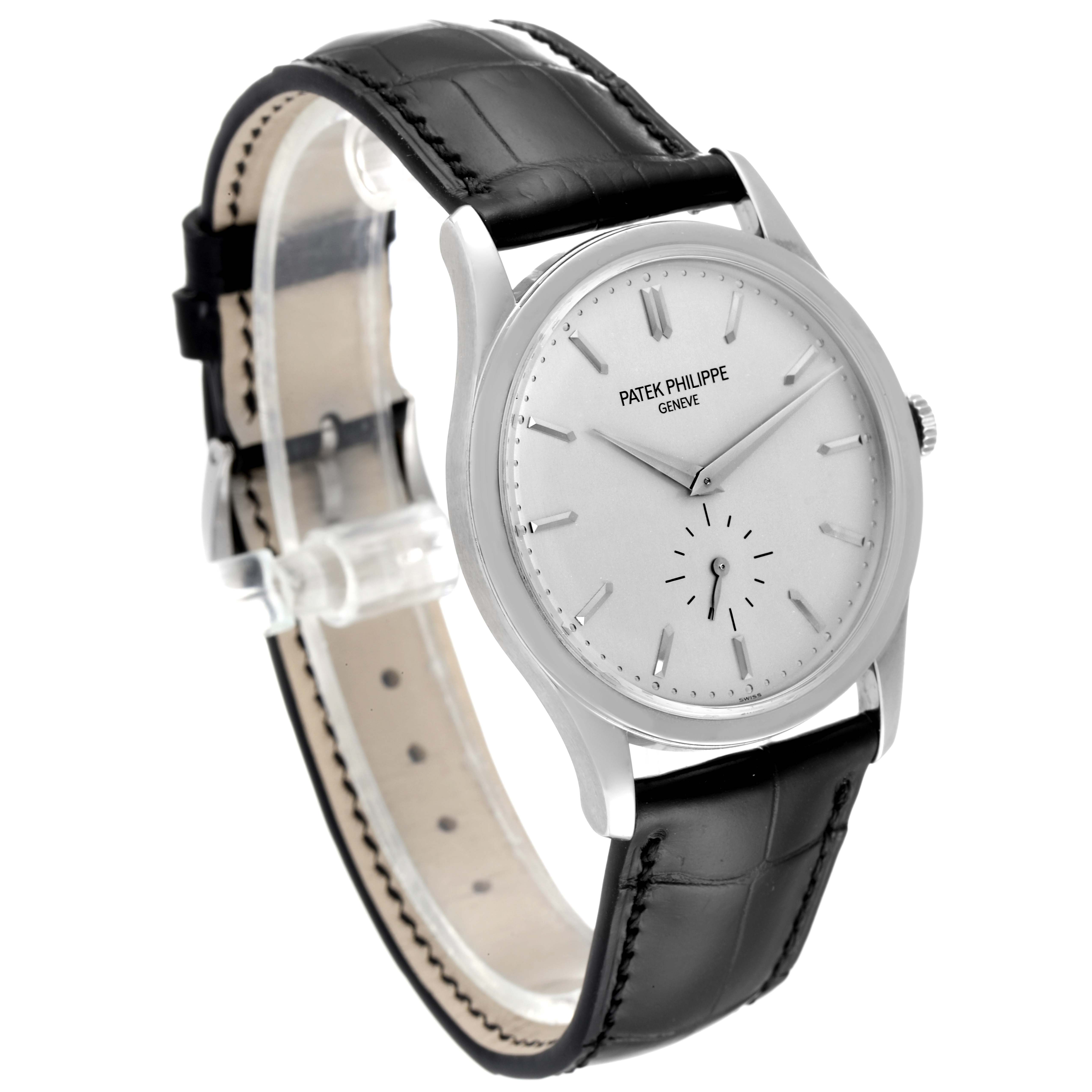 The image shows a side-front angle of the Patek Philippe Calatrava 5196G Men's White Gold Silver Dial 5196G Men's White Gold Silver Dial watch, featuring the watch face, dial, and black leather strap.