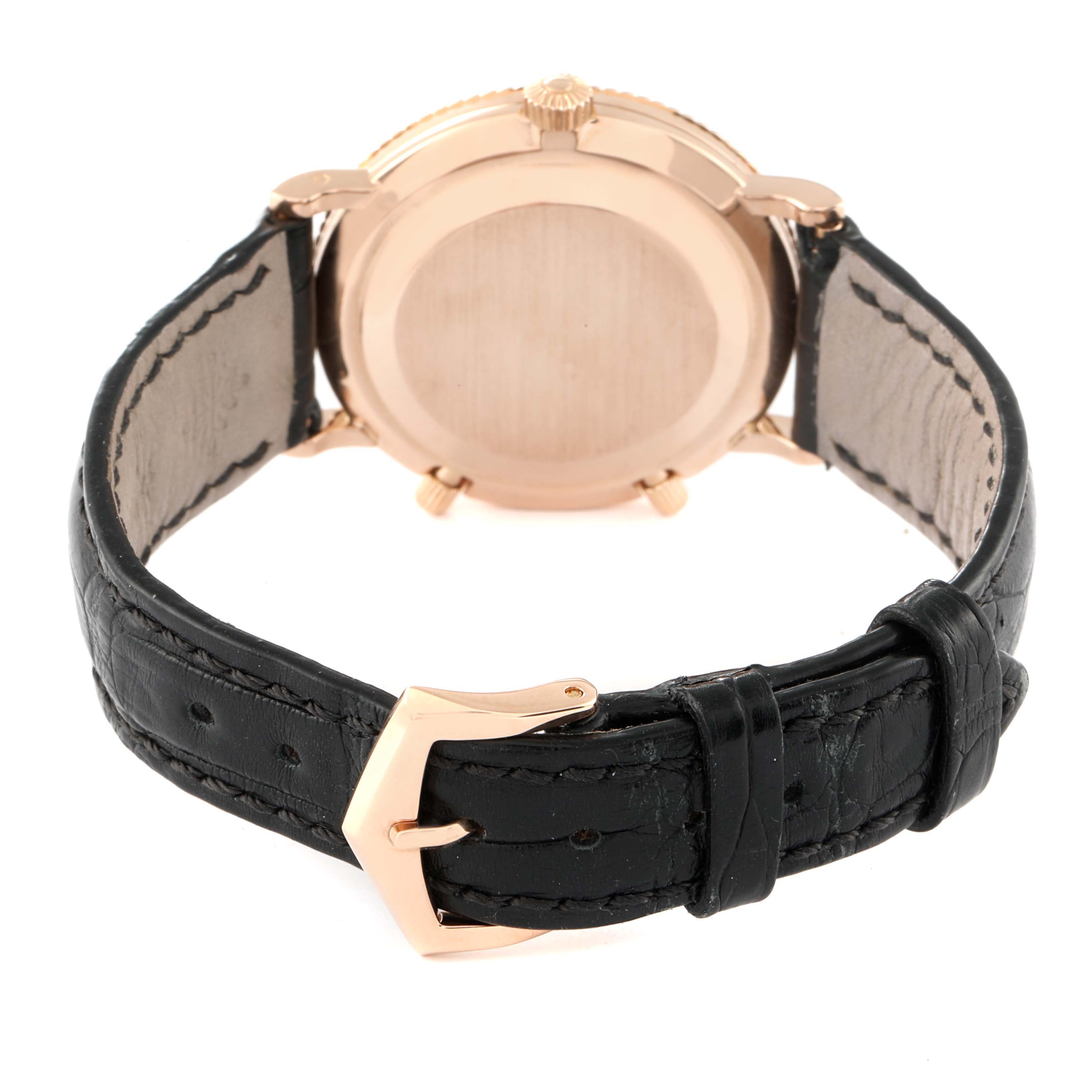 The image shows the back view of the Patek Philippe Calatrava 5034R Men
s Rose Gold White Dial 5034R Men
s Rose Gold White Dial watch, highlighting its case and black leather strap with a buckle.