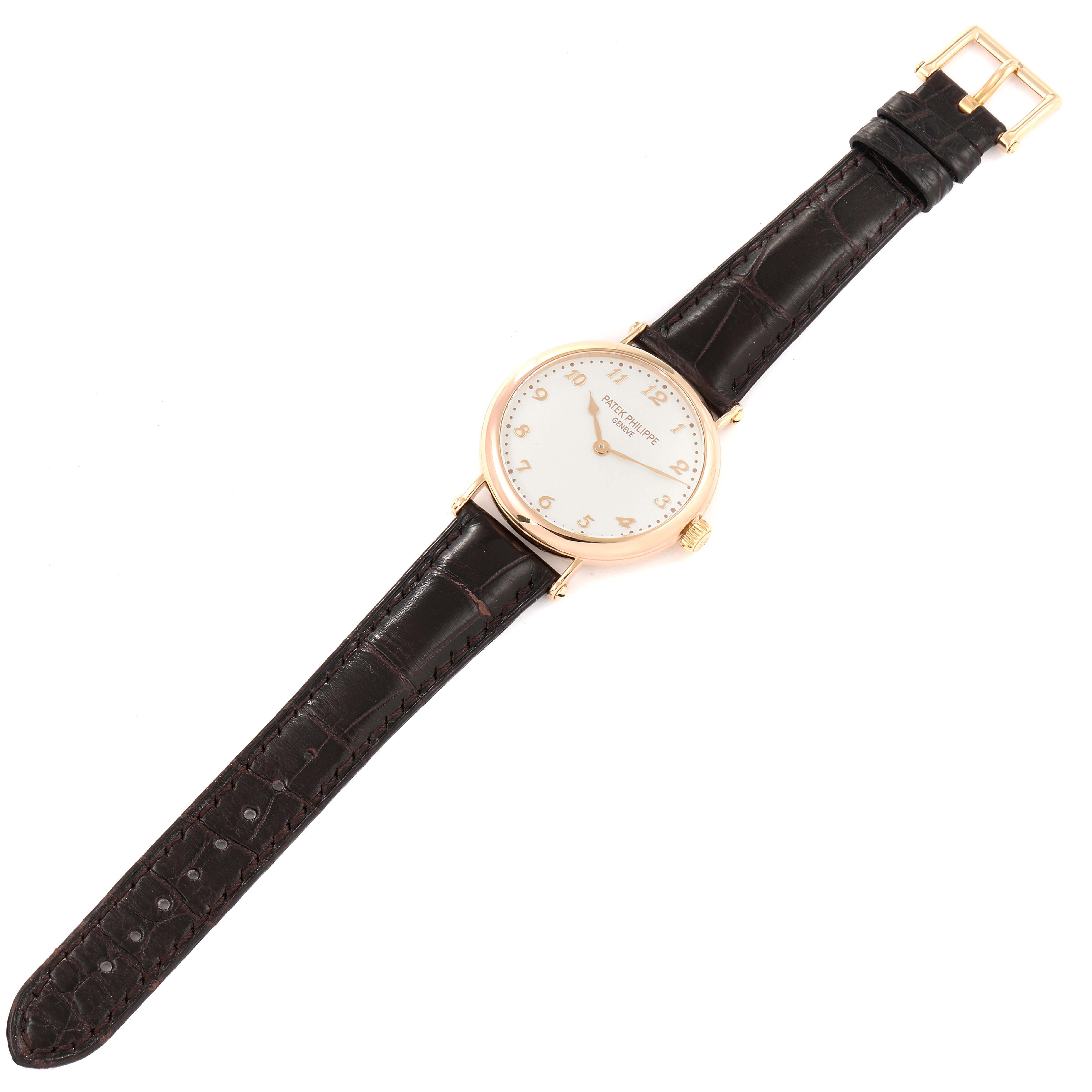 This image shows a Patek Philippe Calatrava 7200R Men
s Rose Gold Silver Dial 7200R Men
s Rose Gold Silver Dial watch from a top-down angle, featuring its face, strap, and buckle.