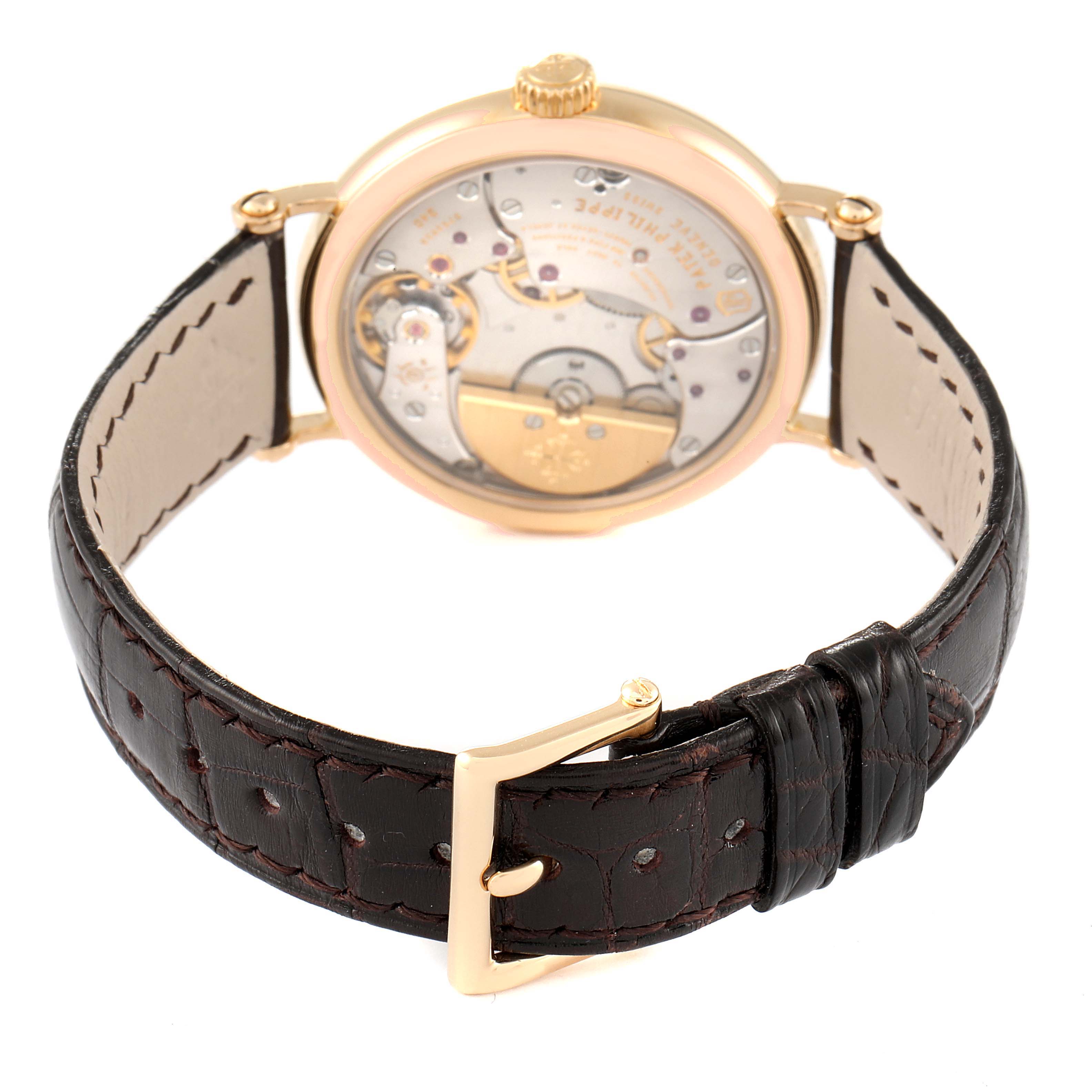 The image shows the back view of a Patek Philippe Calatrava 7200R Men
s Rose Gold Silver Dial 7200R Men
s Rose Gold Silver Dial, highlighting the mechanical movement and leather strap.