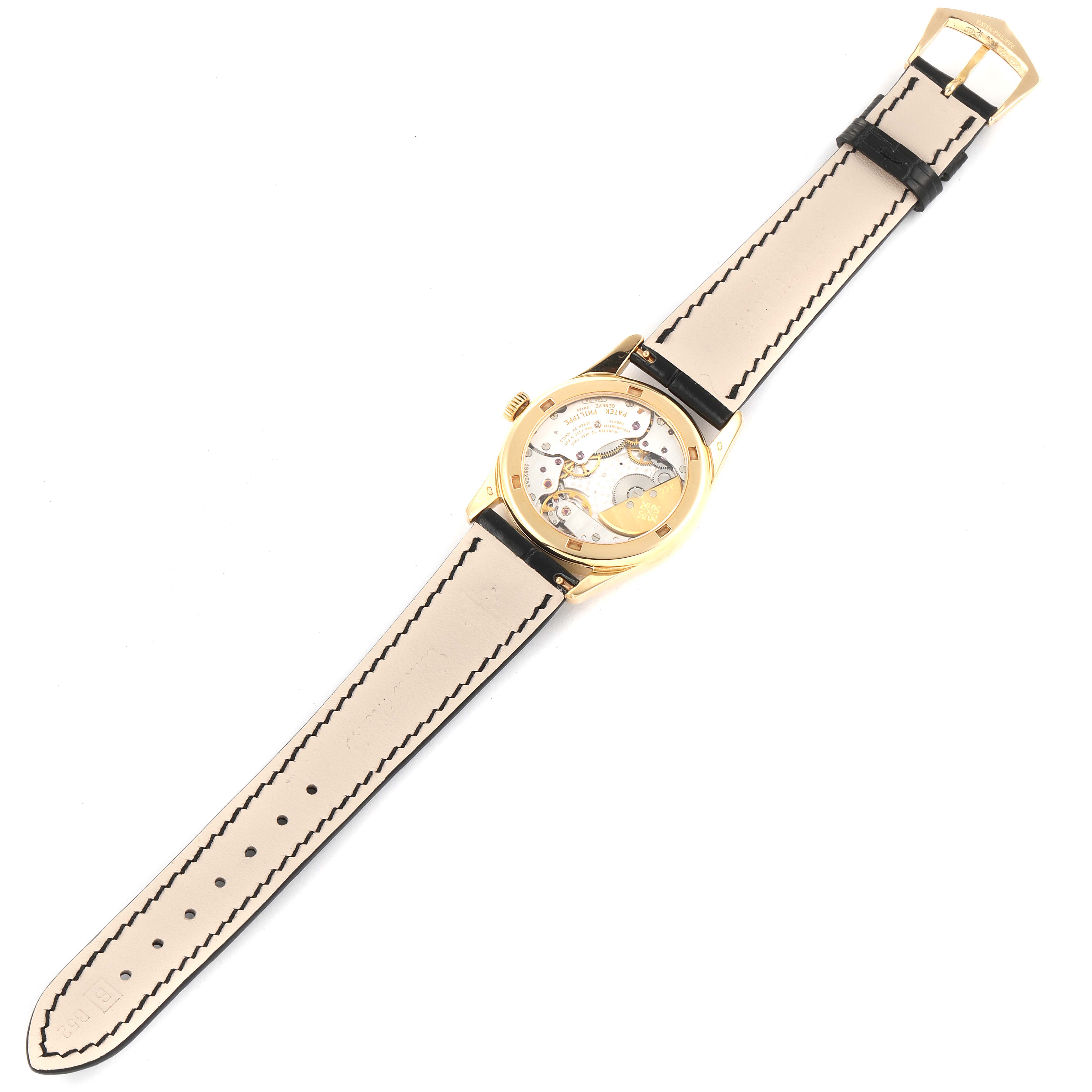 This image shows the back view of the Patek Philippe Calatrava 5000J Women's Yellow Gold Black Dial 5000J Women's Yellow Gold Black Dial watch, displaying its movement and strap.