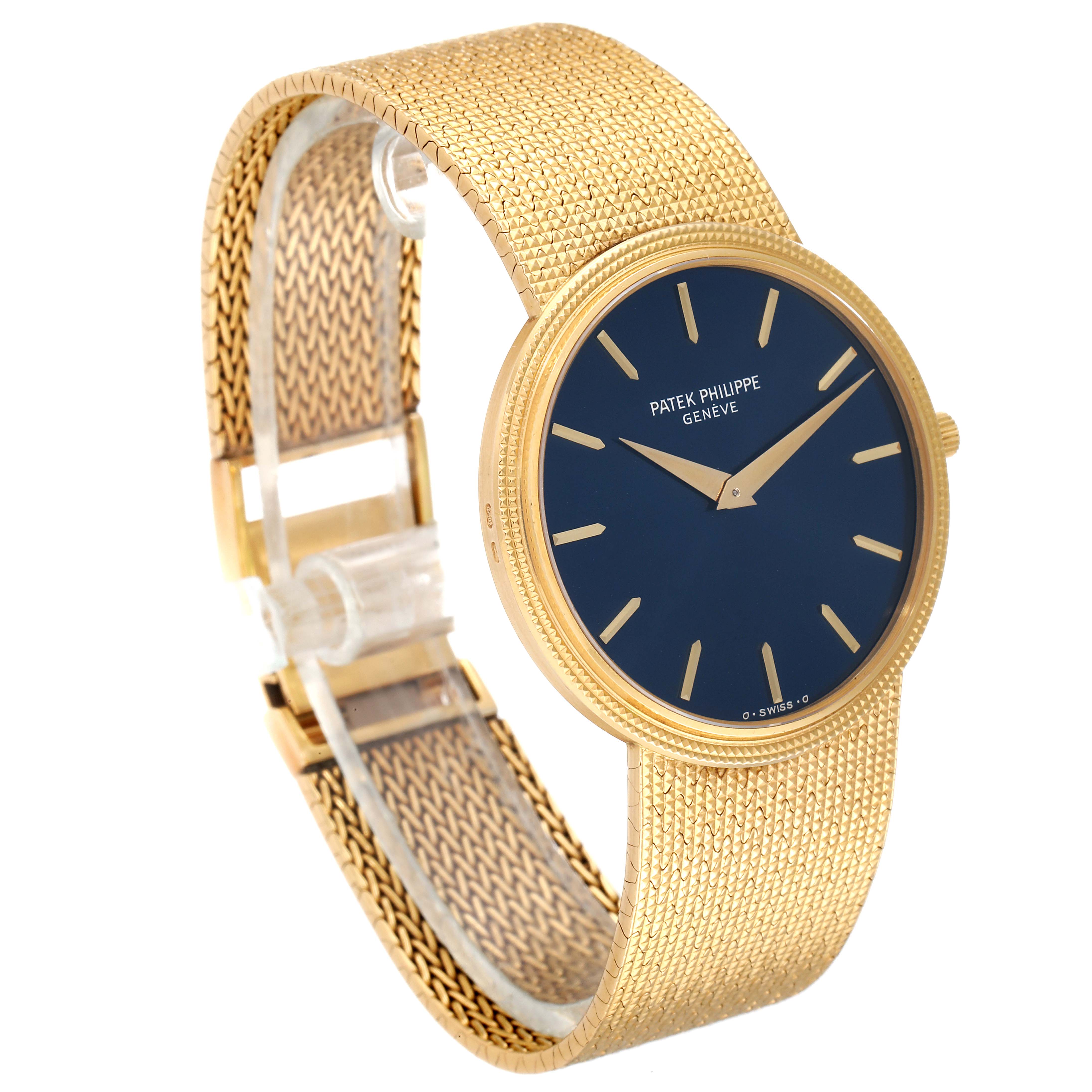 The image shows a Patek Philippe Vintage watch angled to display the gold mesh bracelet and black dial with gold markers.