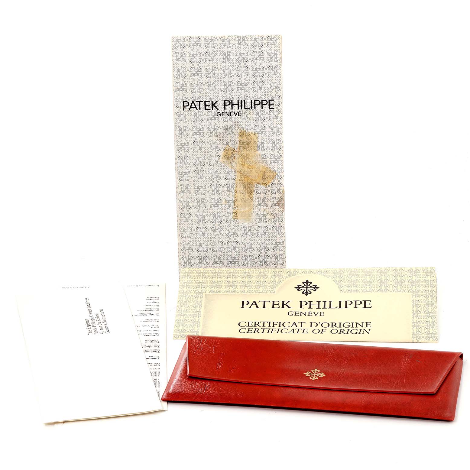 This image shows documentation and a red pouch for a Vintage Patek Philippe watch.