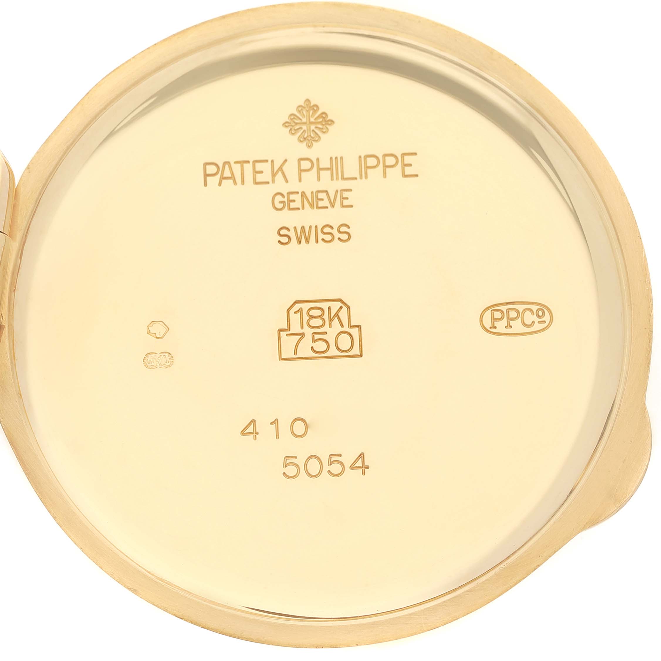 The image shows the back inner cover of a Patek Philippe Complications 5054 Men's Yellow Gold White Dial watch, highlighting engravings and gold markings.